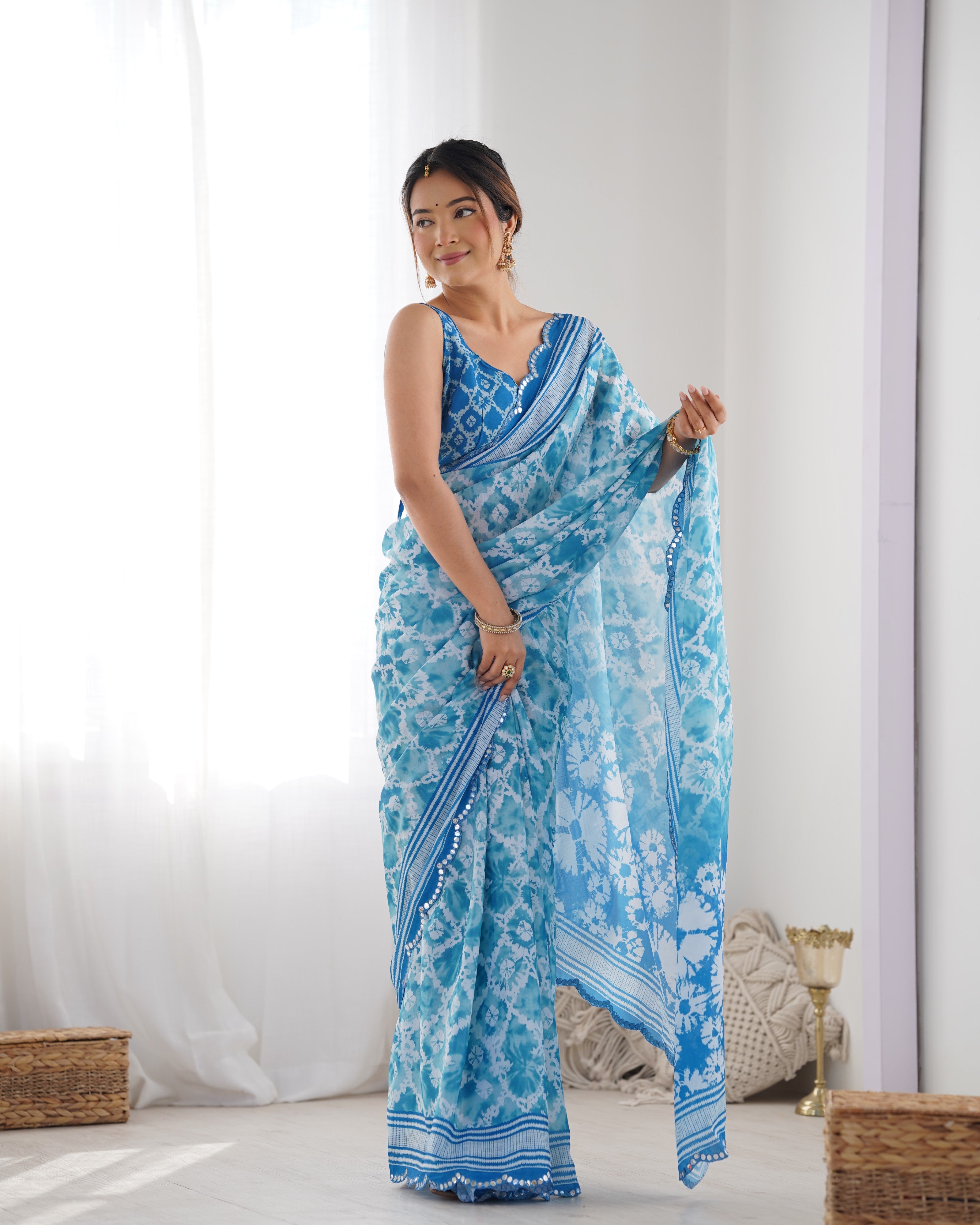 Elegant blue Chinnon saree with Kutchi mirror work lace border
