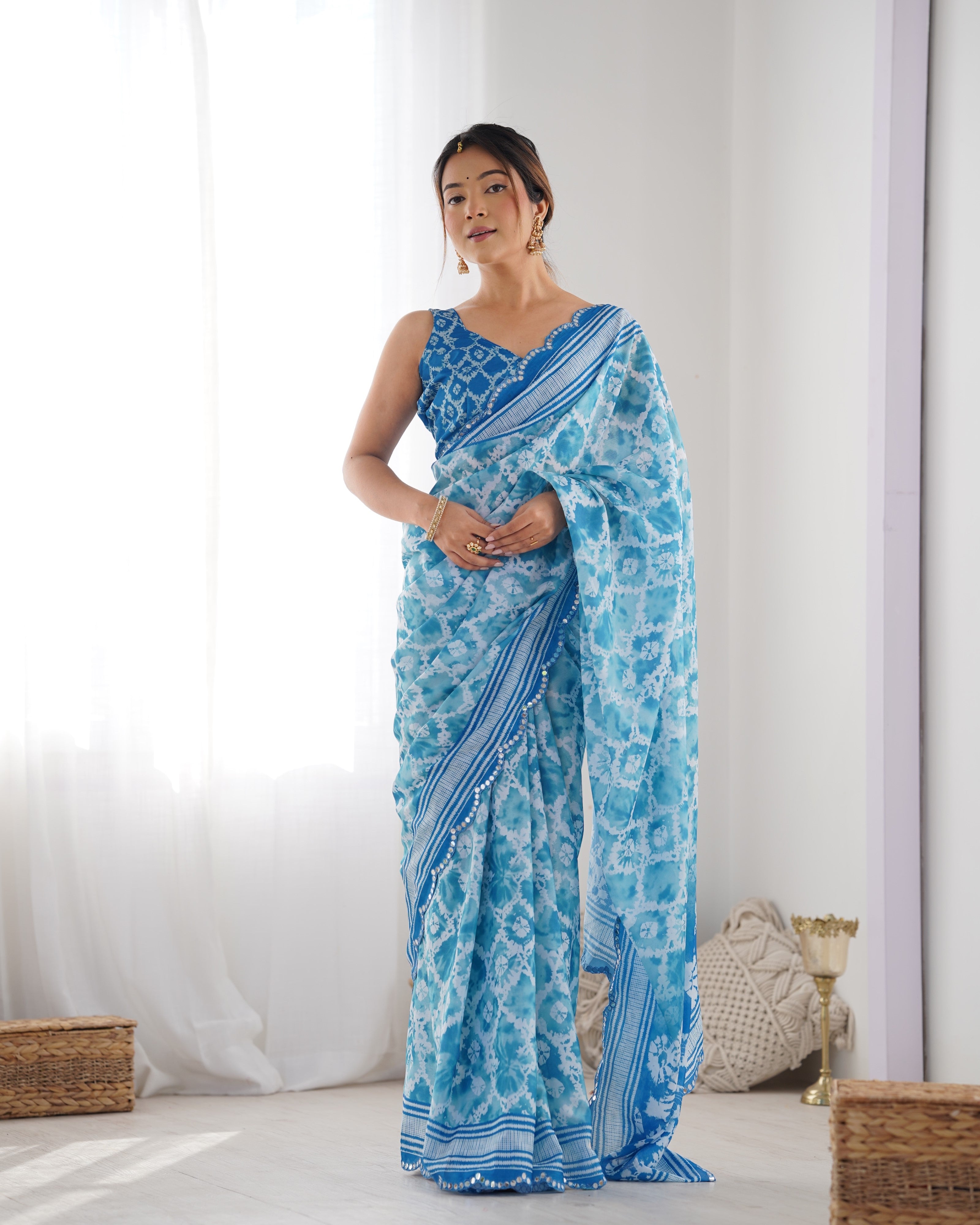 TRENDBUY elegant blue Chinnon saree with detailed Kutchi mirror work lace border
