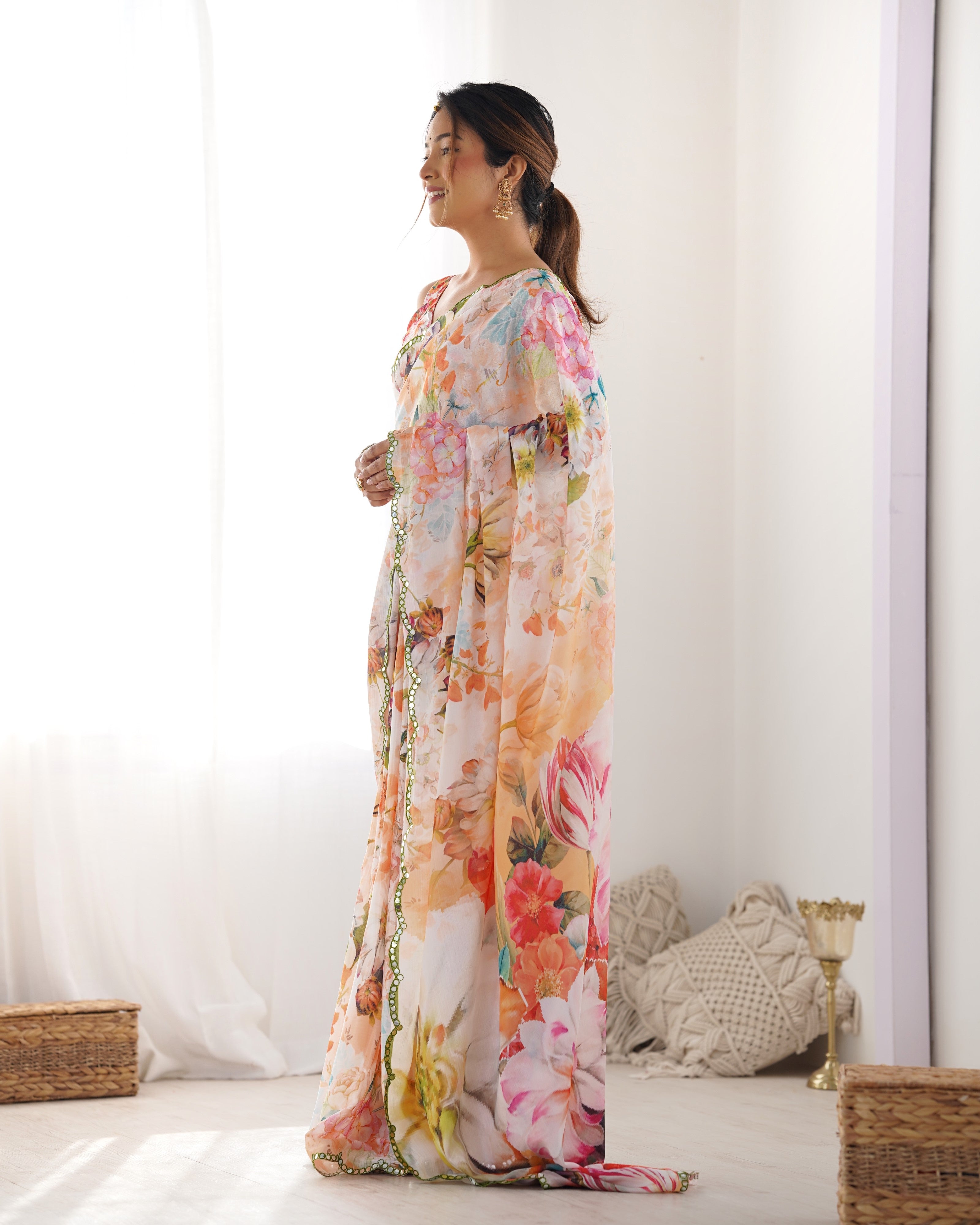 Model in an elegant heavy chinnon floral print saree with Kutchi mirror lace border, side profile. TRENDBUY DVS-22.