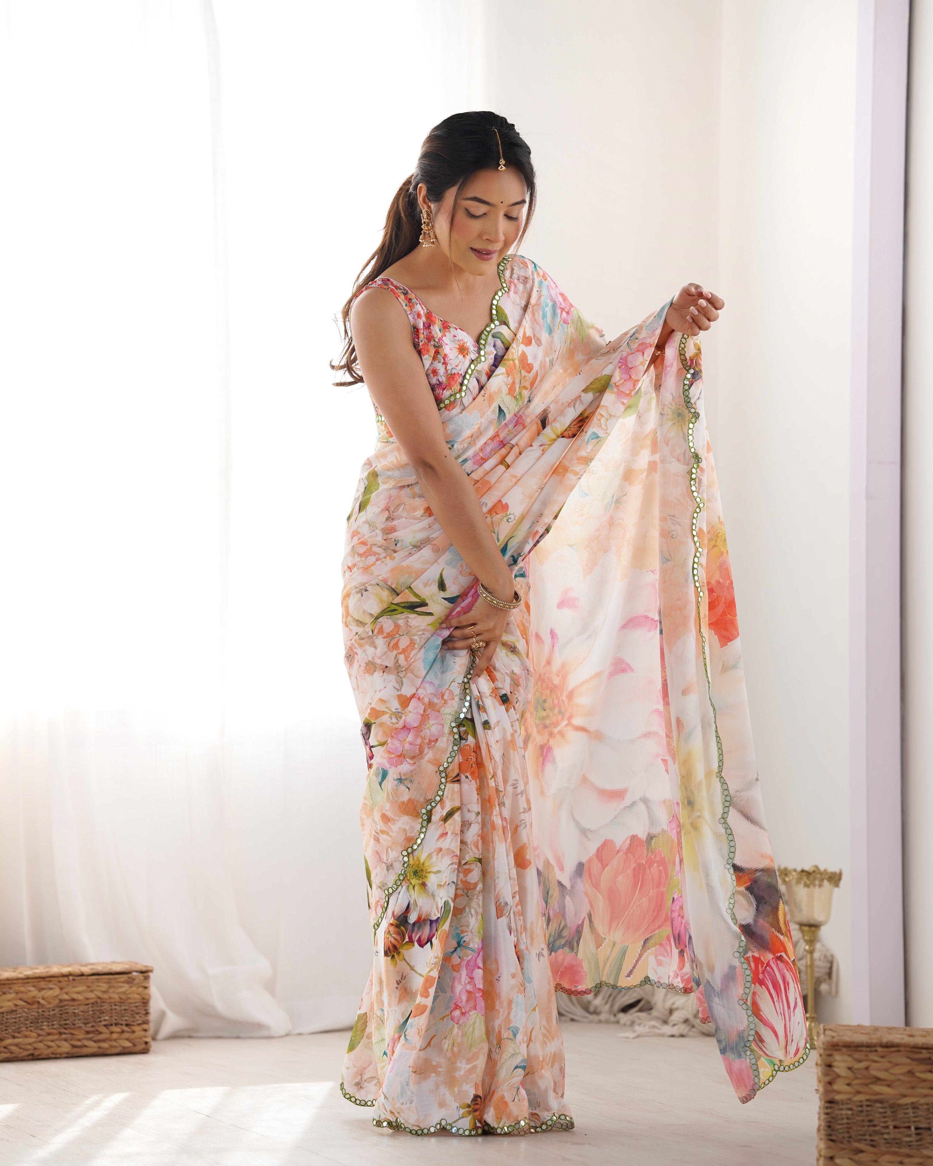 Woman showcasing the graceful drape and vibrant floral print of the TRENDBUY heavy chinnon saree with mirror work.