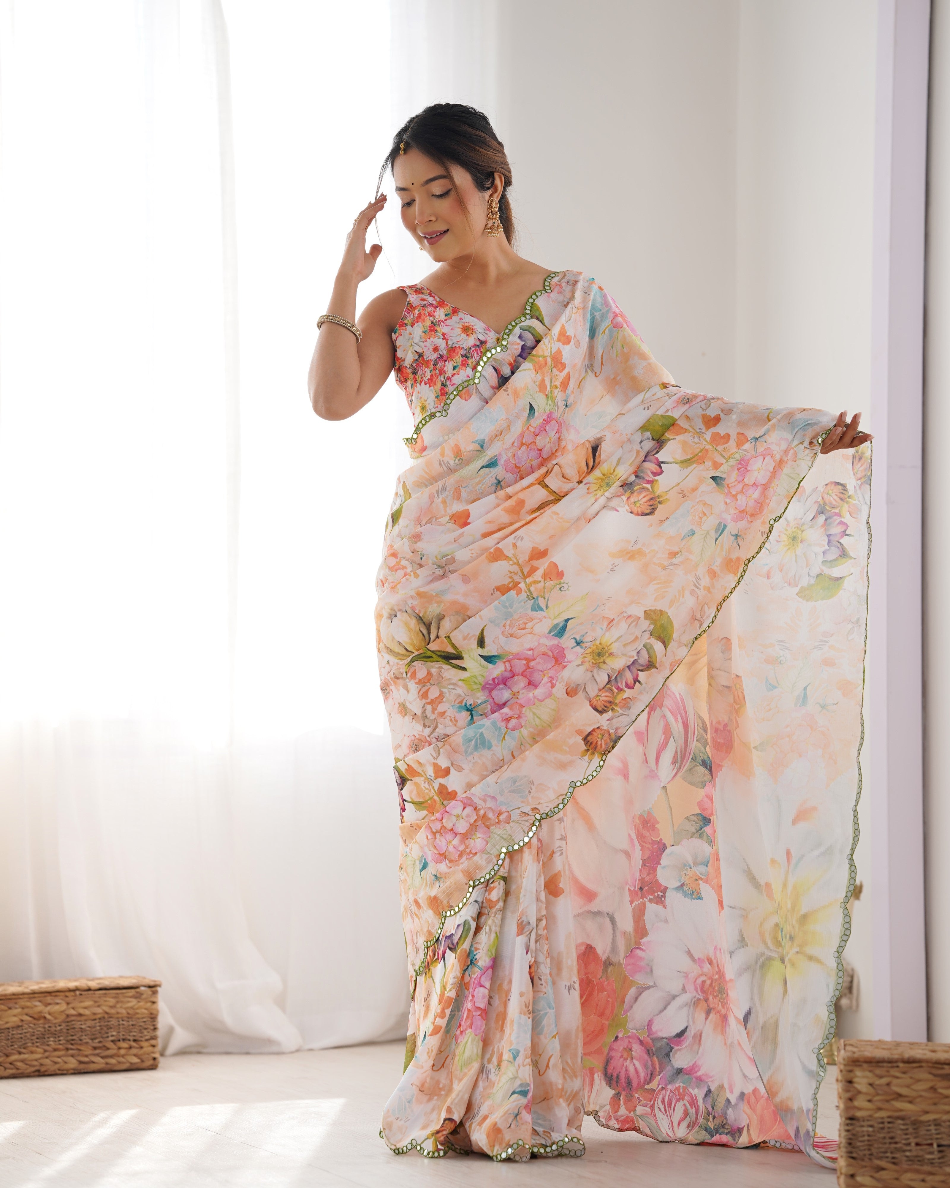 Woman admiring the intricate Kutchi mirror lace border details on her chinnon saree from TRENDBUY.
