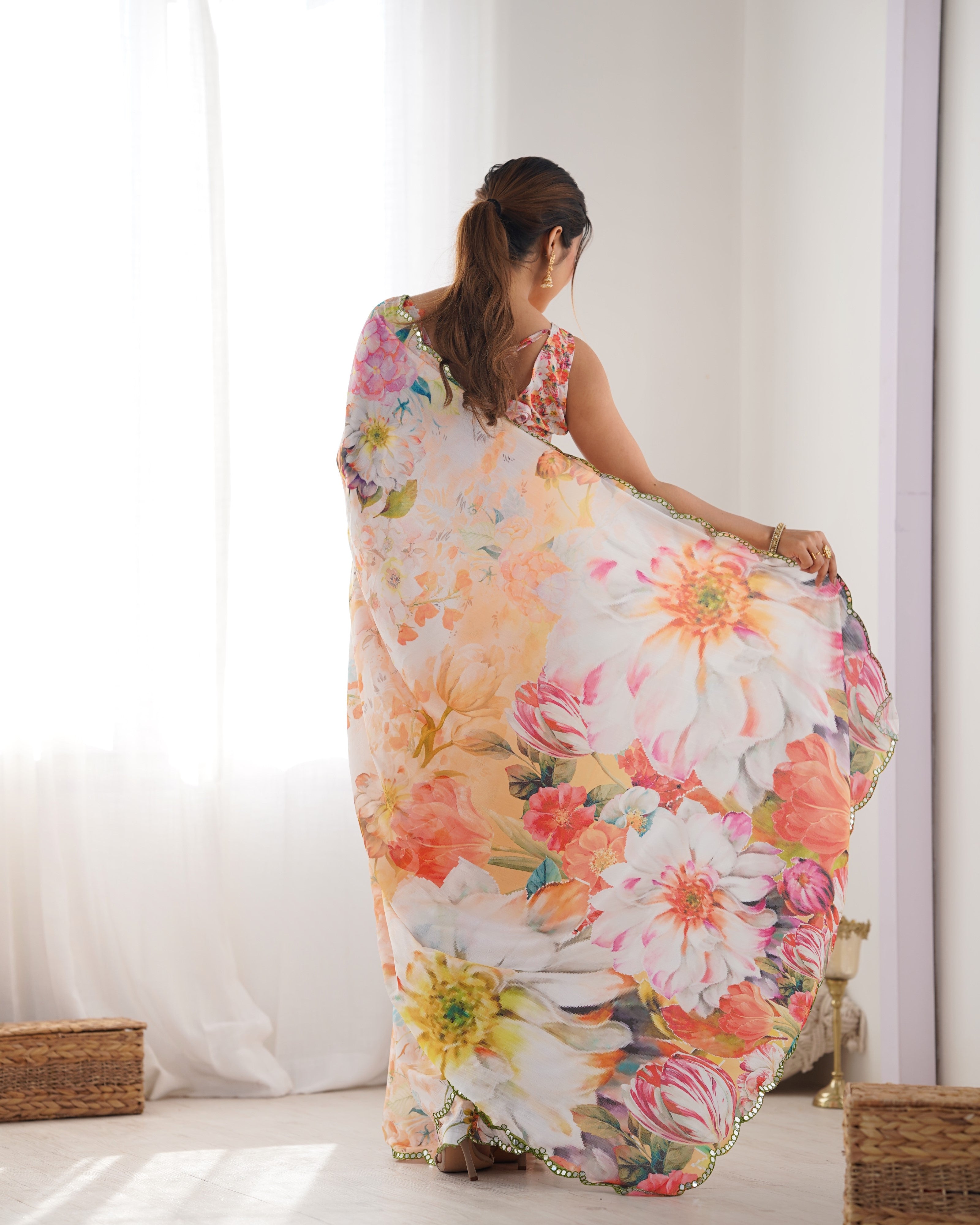 Back view of woman gracefully twirling in the TRENDBUY DVS-22 printed saree, highlighting the voluminous drape.