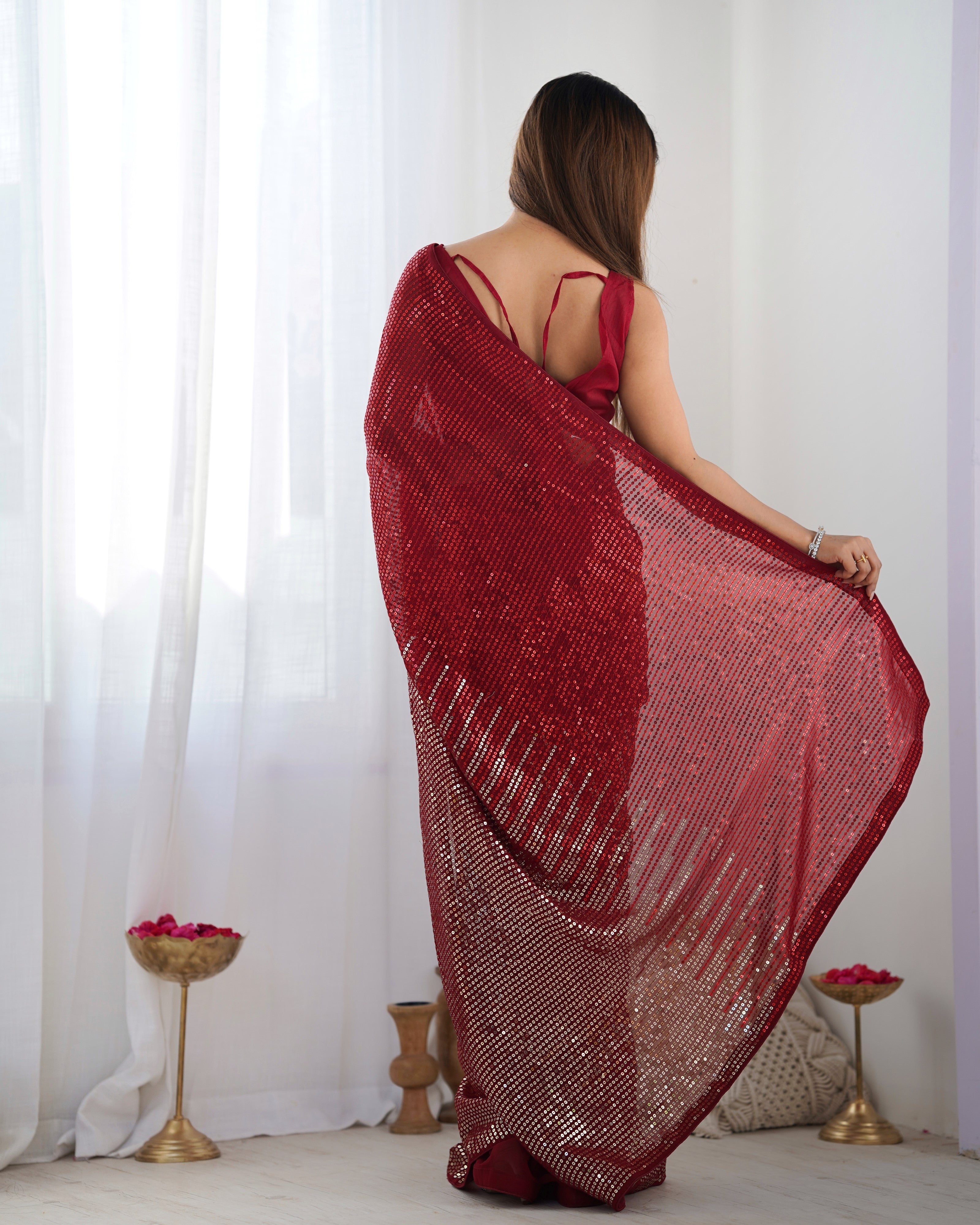 Back view of woman in TRENDBUY DVS-23 Ruby Red Georgette Saree showcasing drape