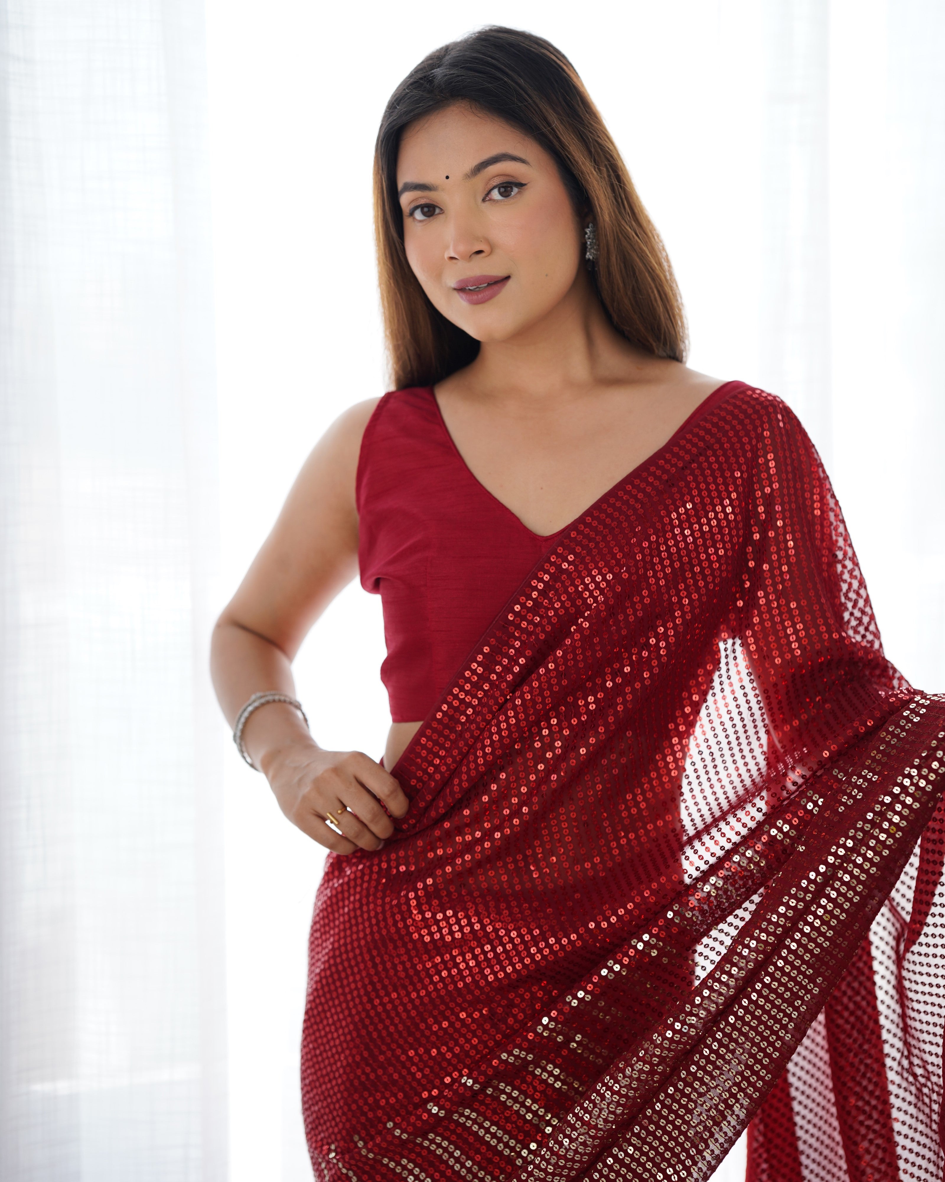 Close-up of woman smiling in TRENDBUY DVS-23 Ruby Red Saree with sequin work and unstitched blouse