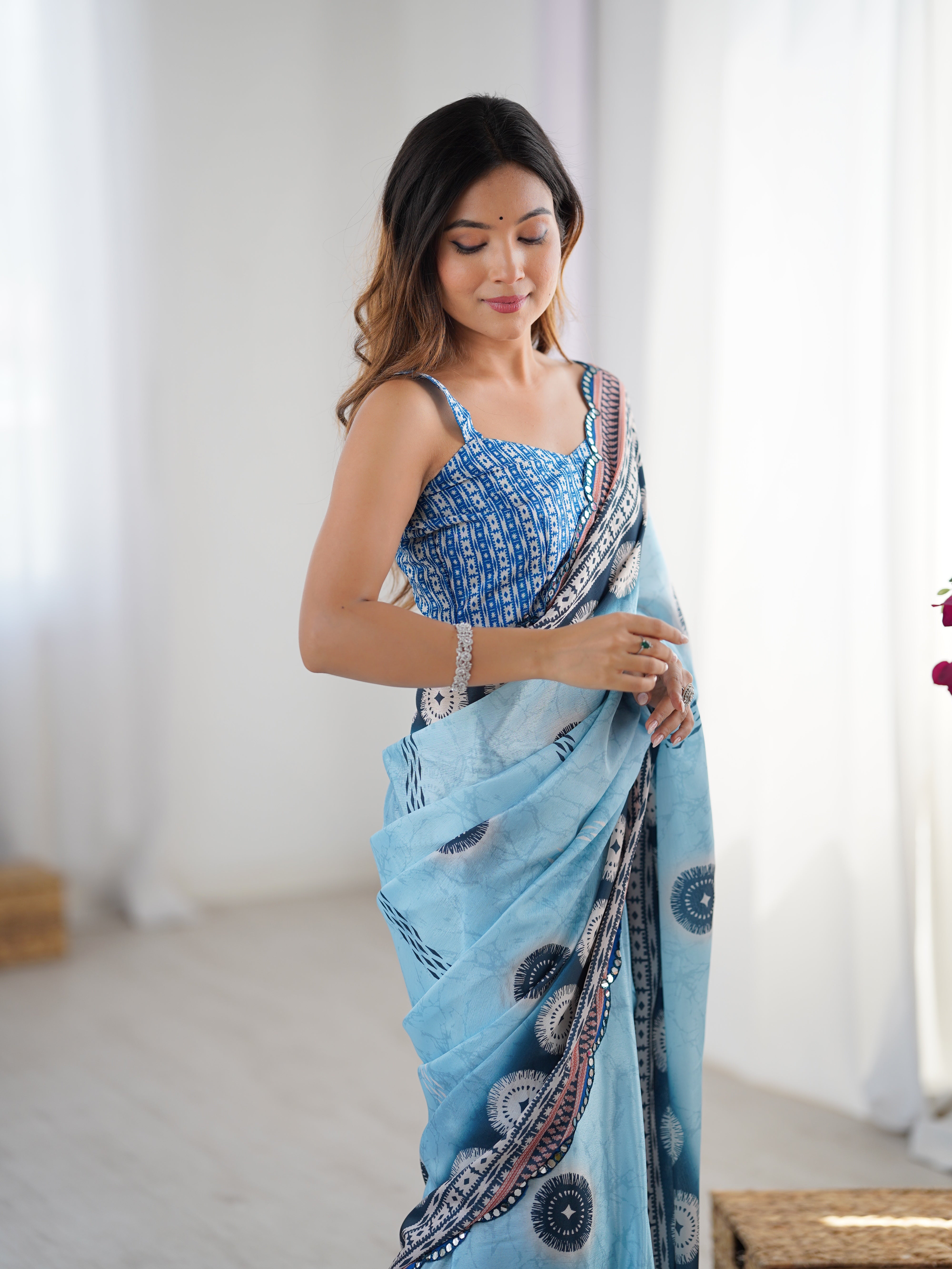 TRENDBUY Exclusive Heavy Chinnon Saree with intricate Kutchi work and shimmering mirror lace border.