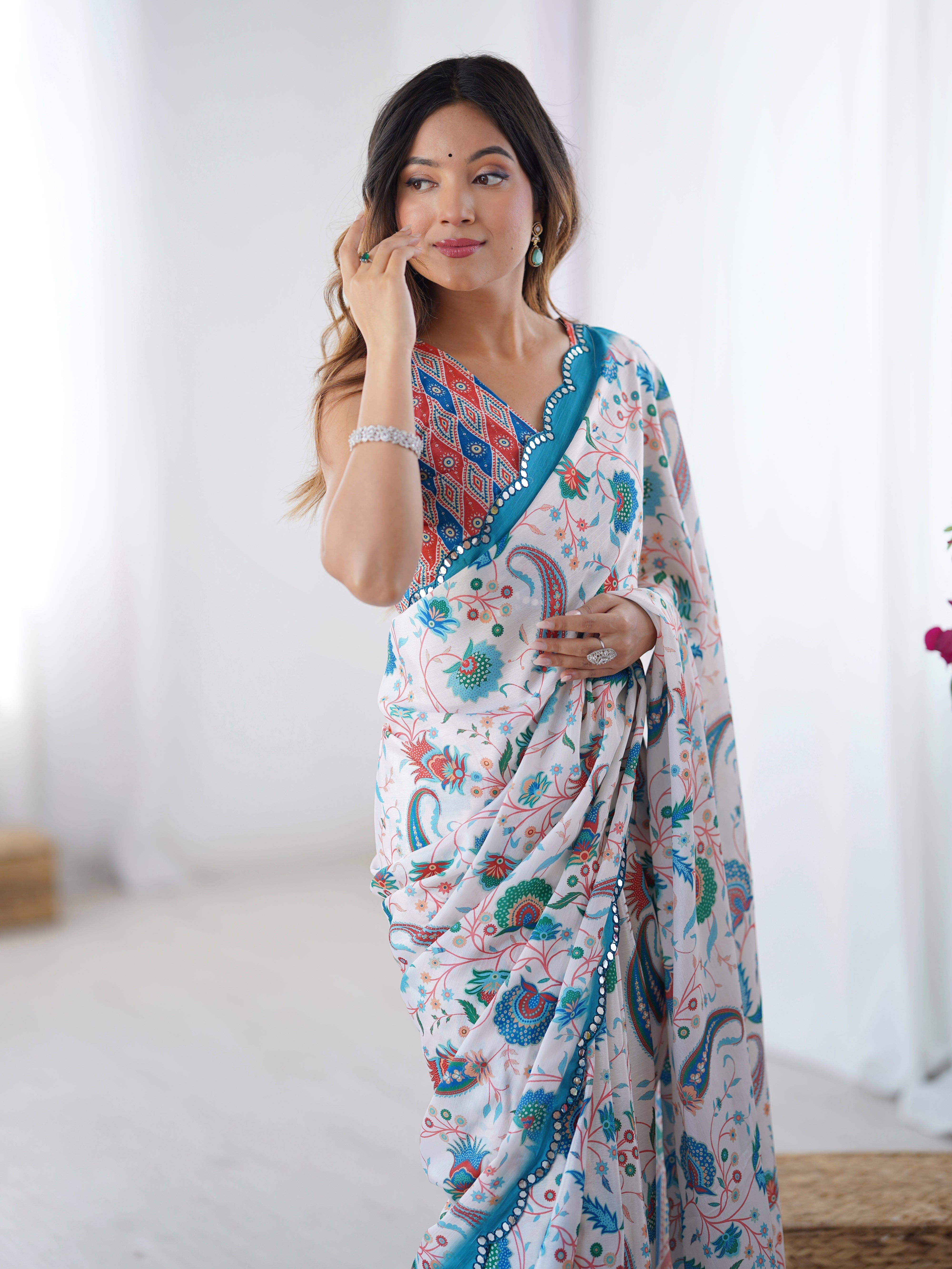 Close-up of model's profile, revealing the intricate Kutchi mirror work on the blue border of the TRENDBUY DVS-28 Chinnon saree and her matching jewelry.