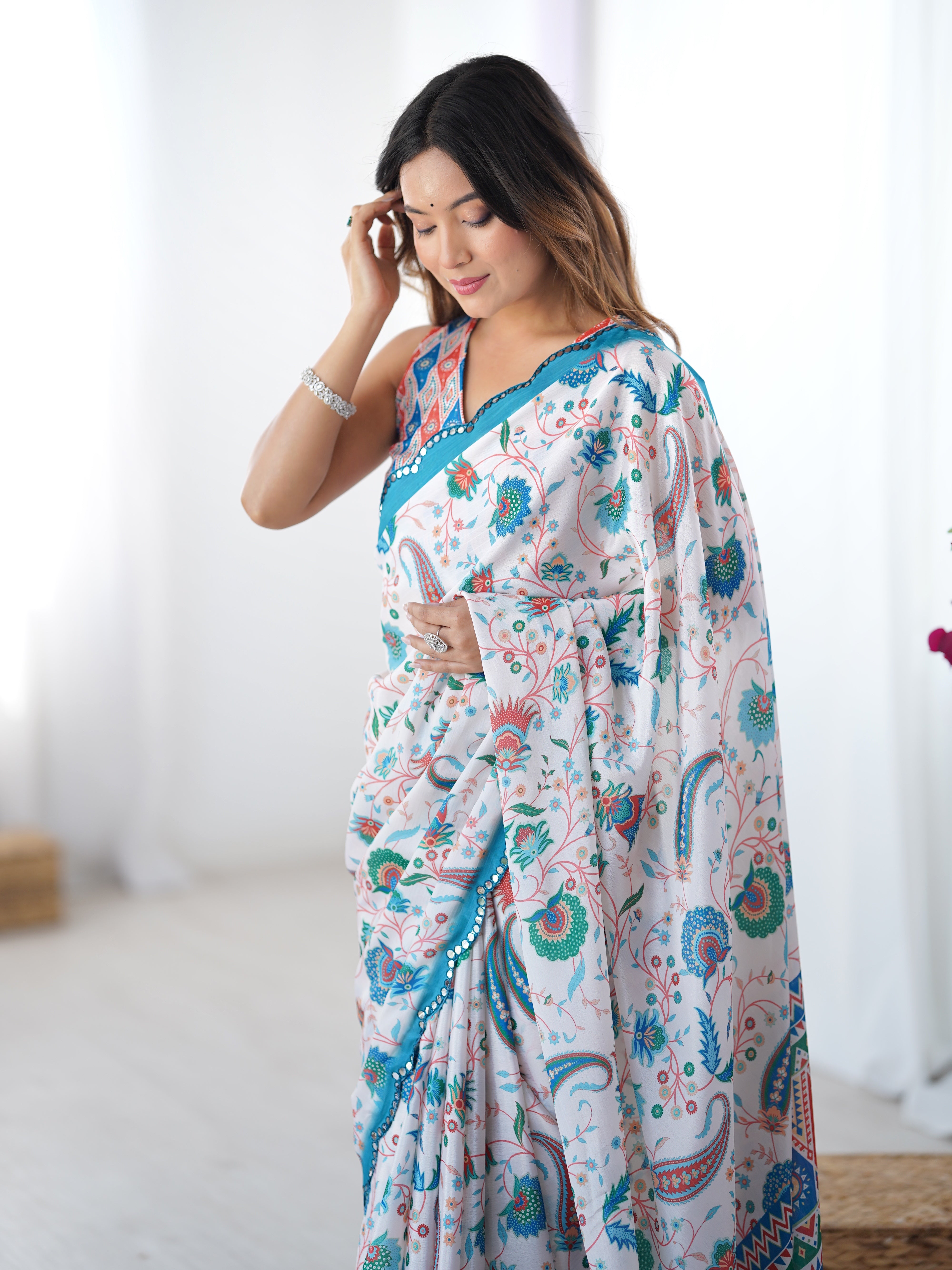 Model looking down, hands clasped, emphasizing the beautiful drape and detailed print of the TRENDBUY DVS-28 heavy Chinnon saree.