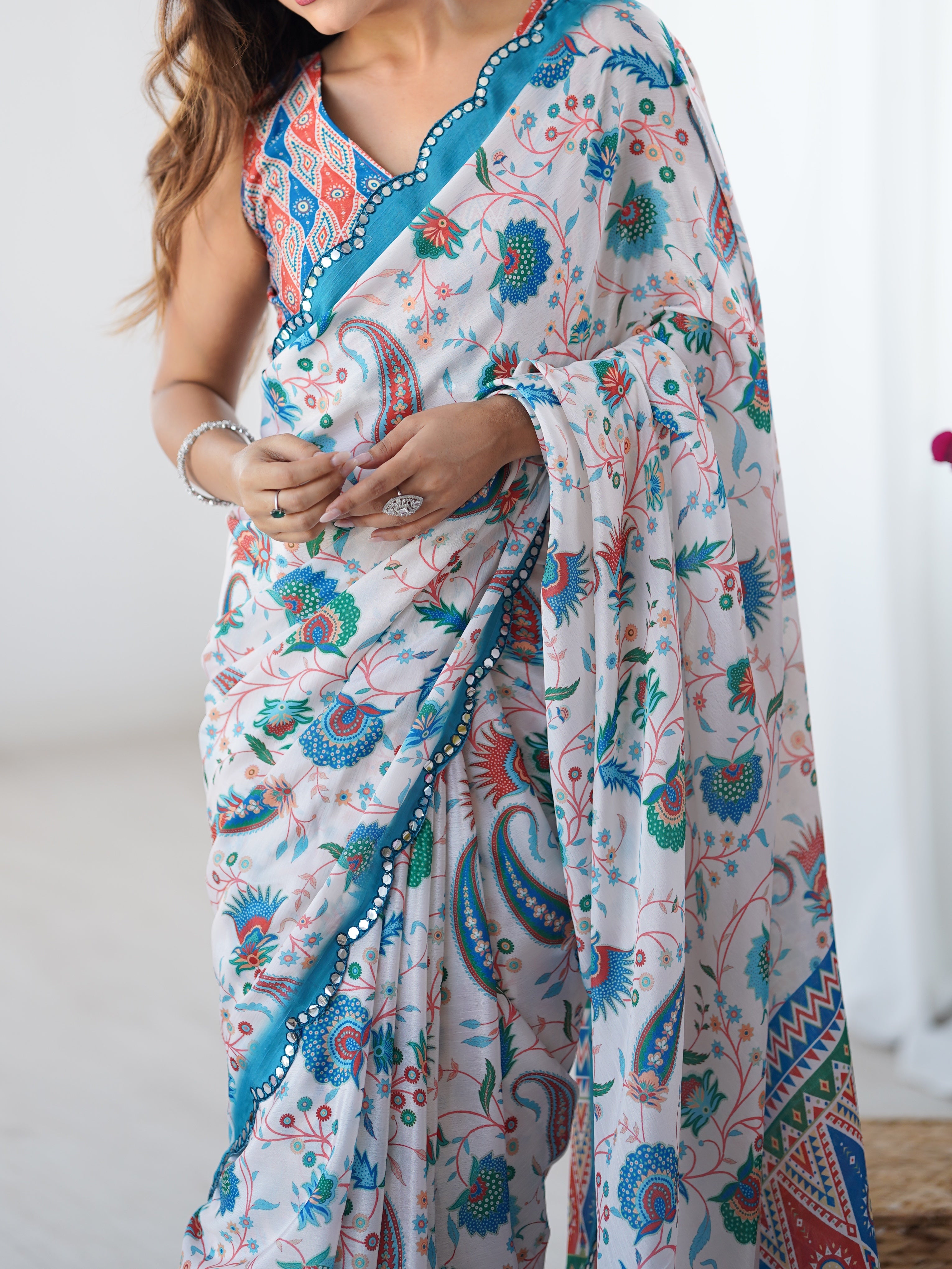 Mid-section view of the TRENDBUY DVS-28 Chinnon saree, focusing on the rich print and the sparkling Kutchi mirror lace border.