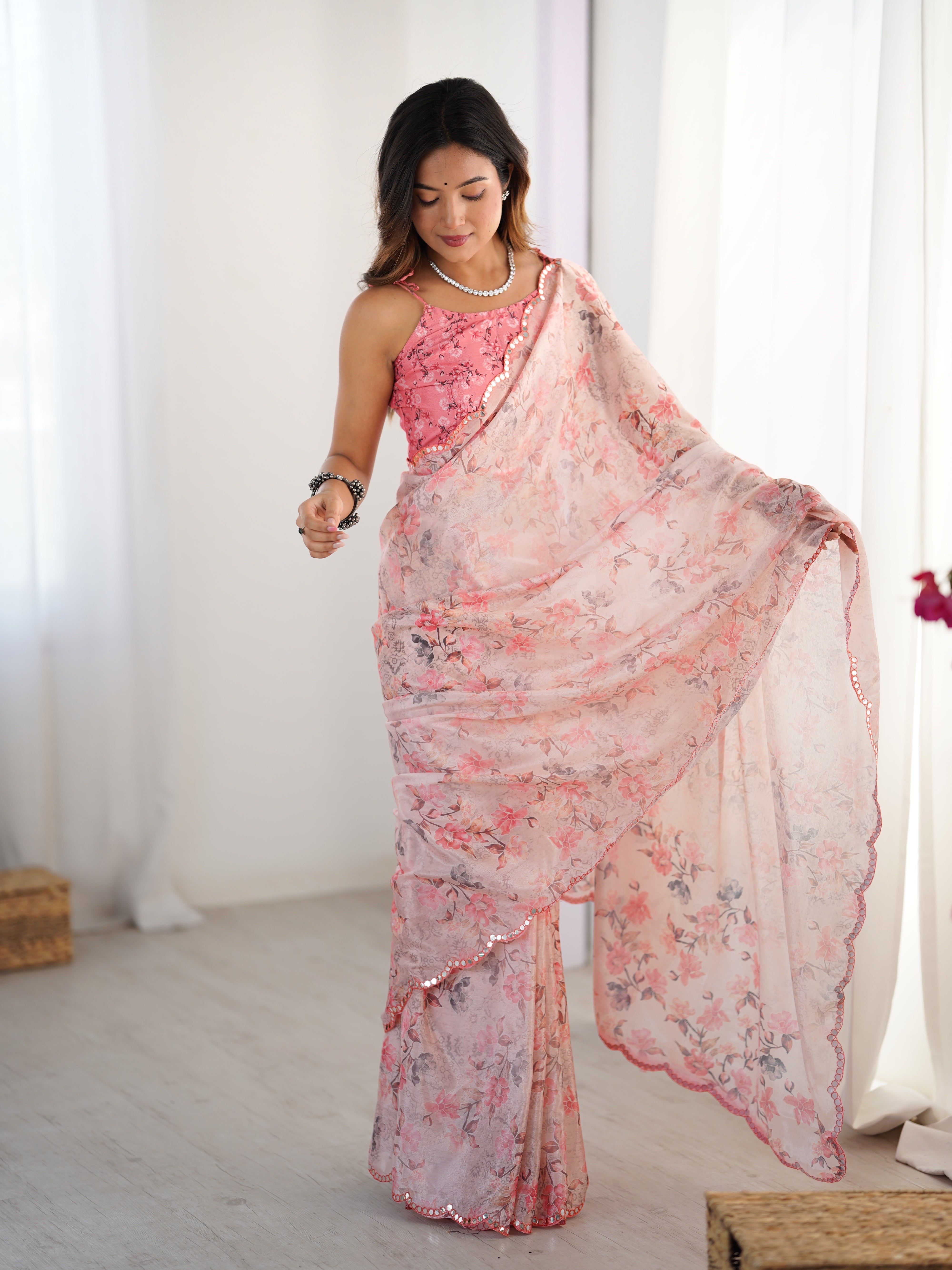 TRENDBUY model showcasing a beautiful light pink heavy chinnon floral print saree with mirror work lace, posing gracefully.