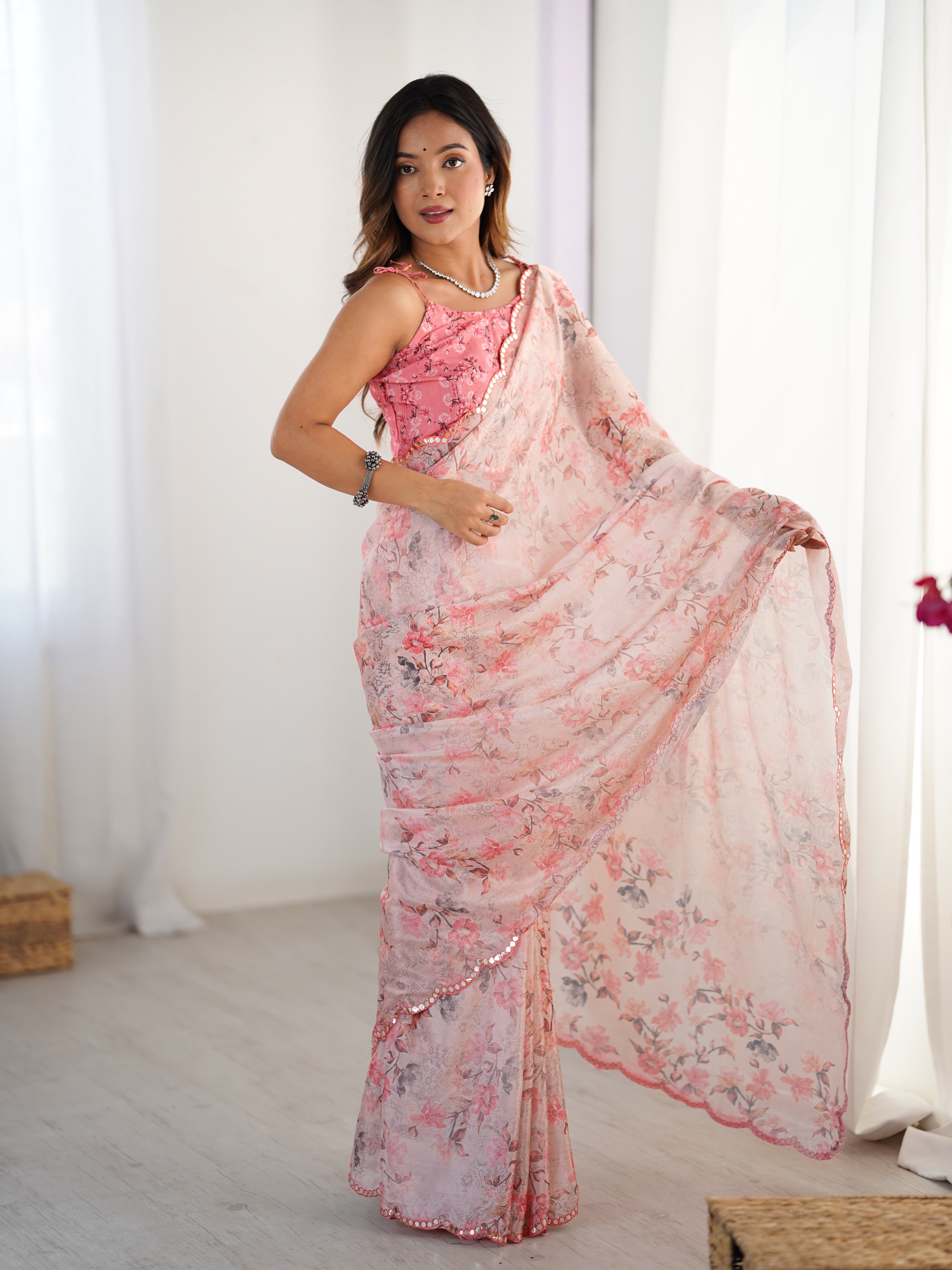 Full-length shot of the model in the light pink floral chinnon saree, confidently posing and highlighting the saree's elegance.