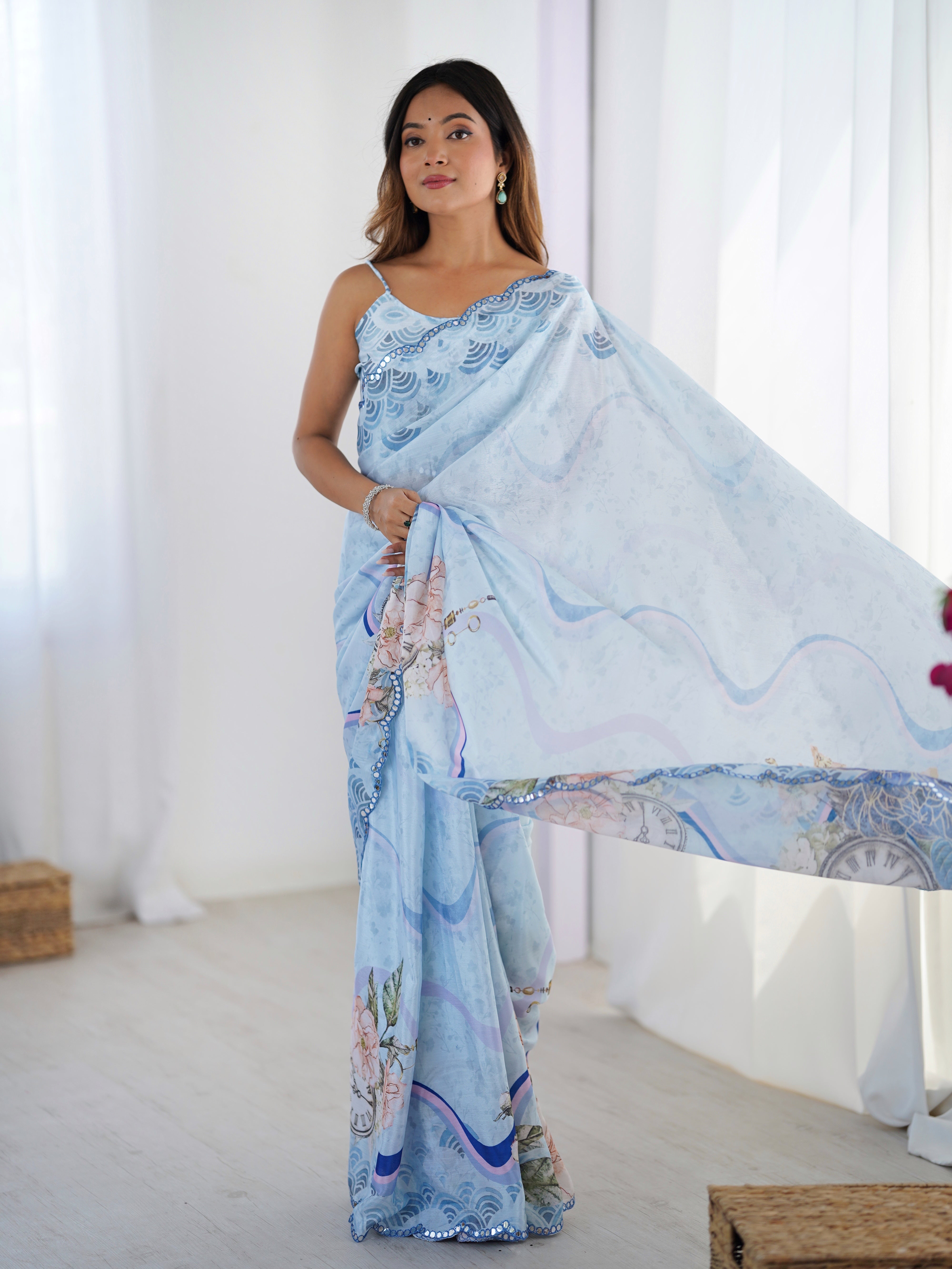 Elegant sky blue Chinnon saree with Kutchi work mirror lace border and unstitched blouse.