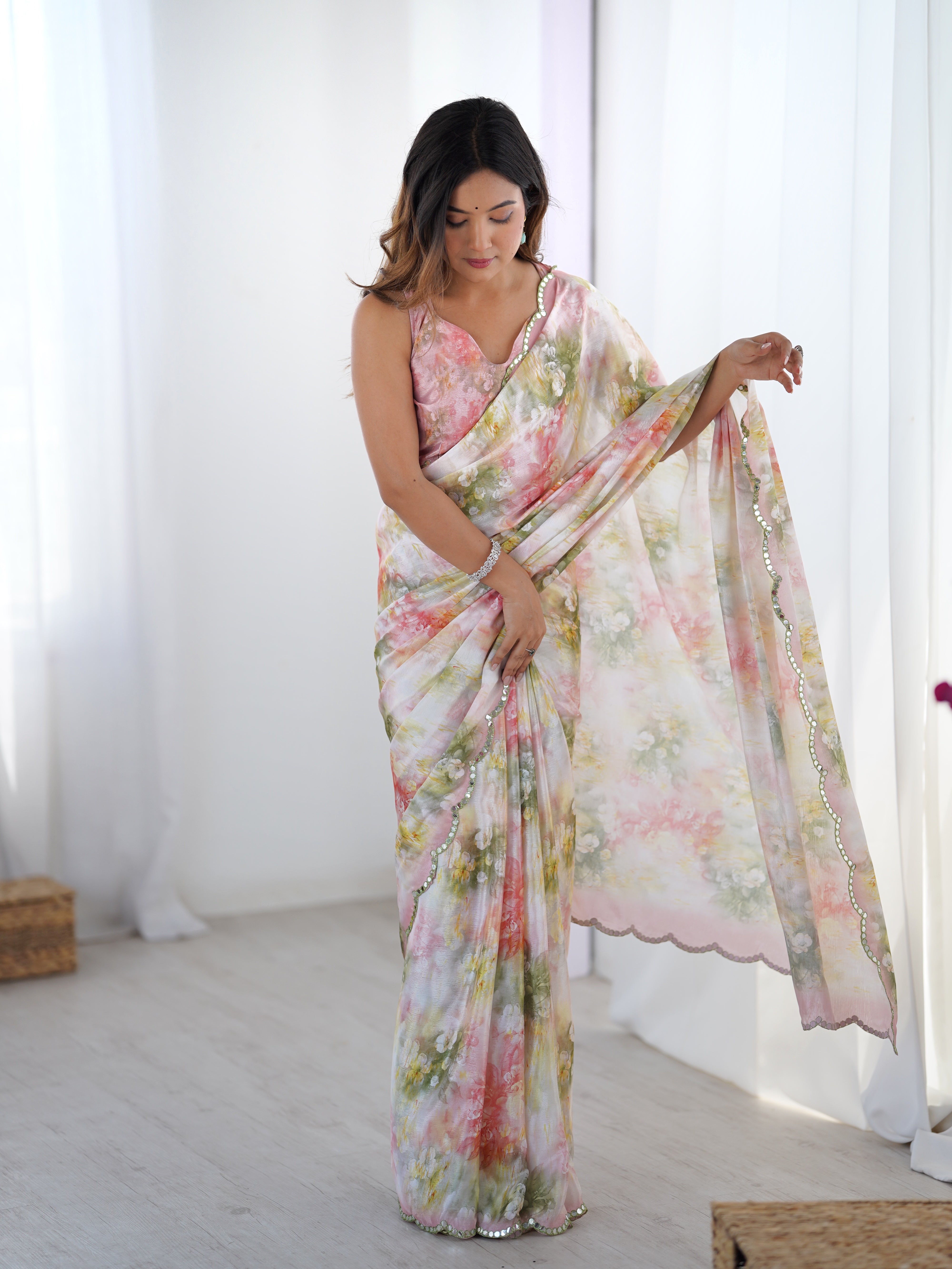 Elegant heavy Chinnon saree with floral print and intricate Kutchi mirror lace border.