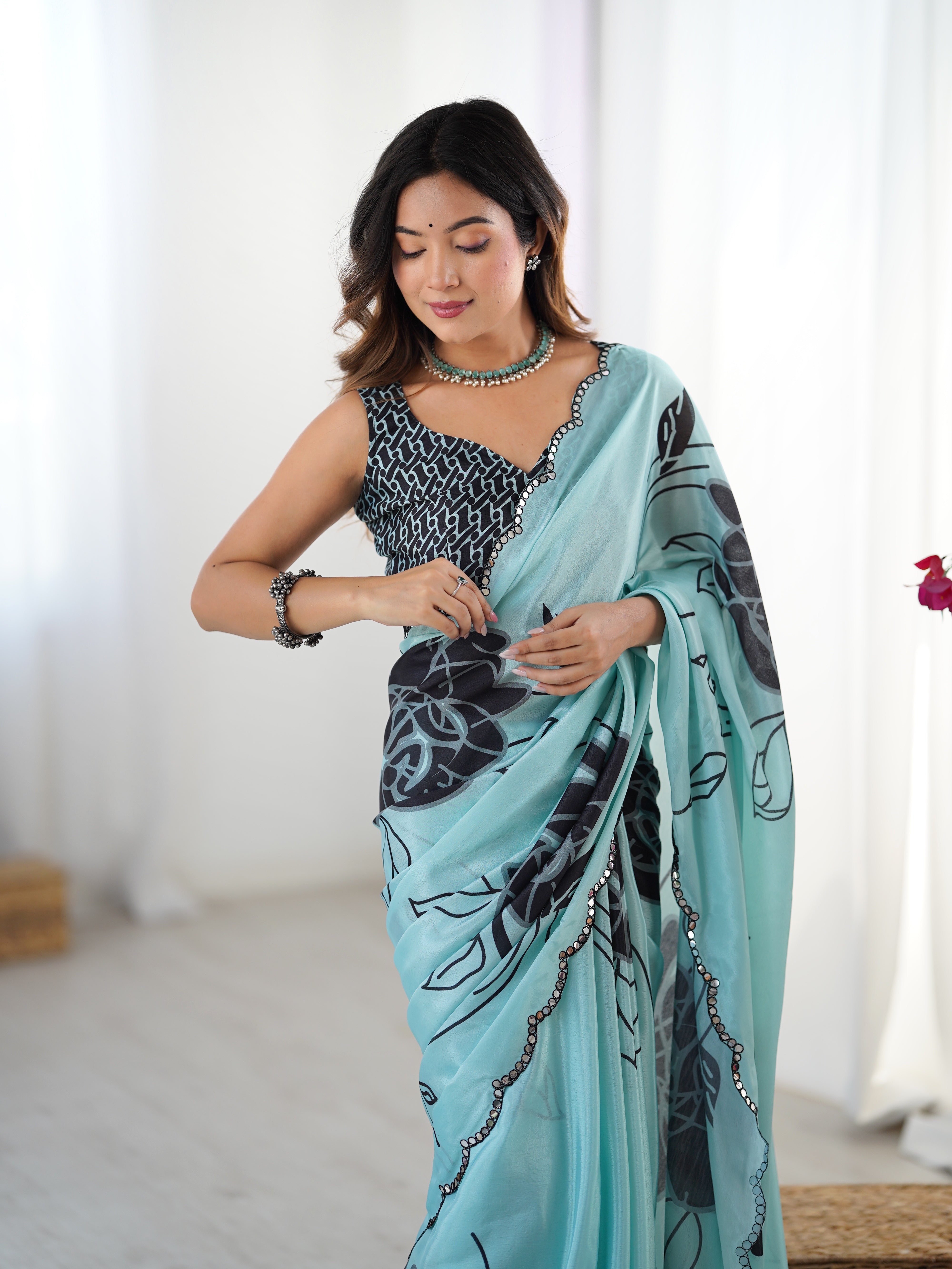 Elegant sky blue heavy chinnon saree with floral print and Kutchi mirror lace border