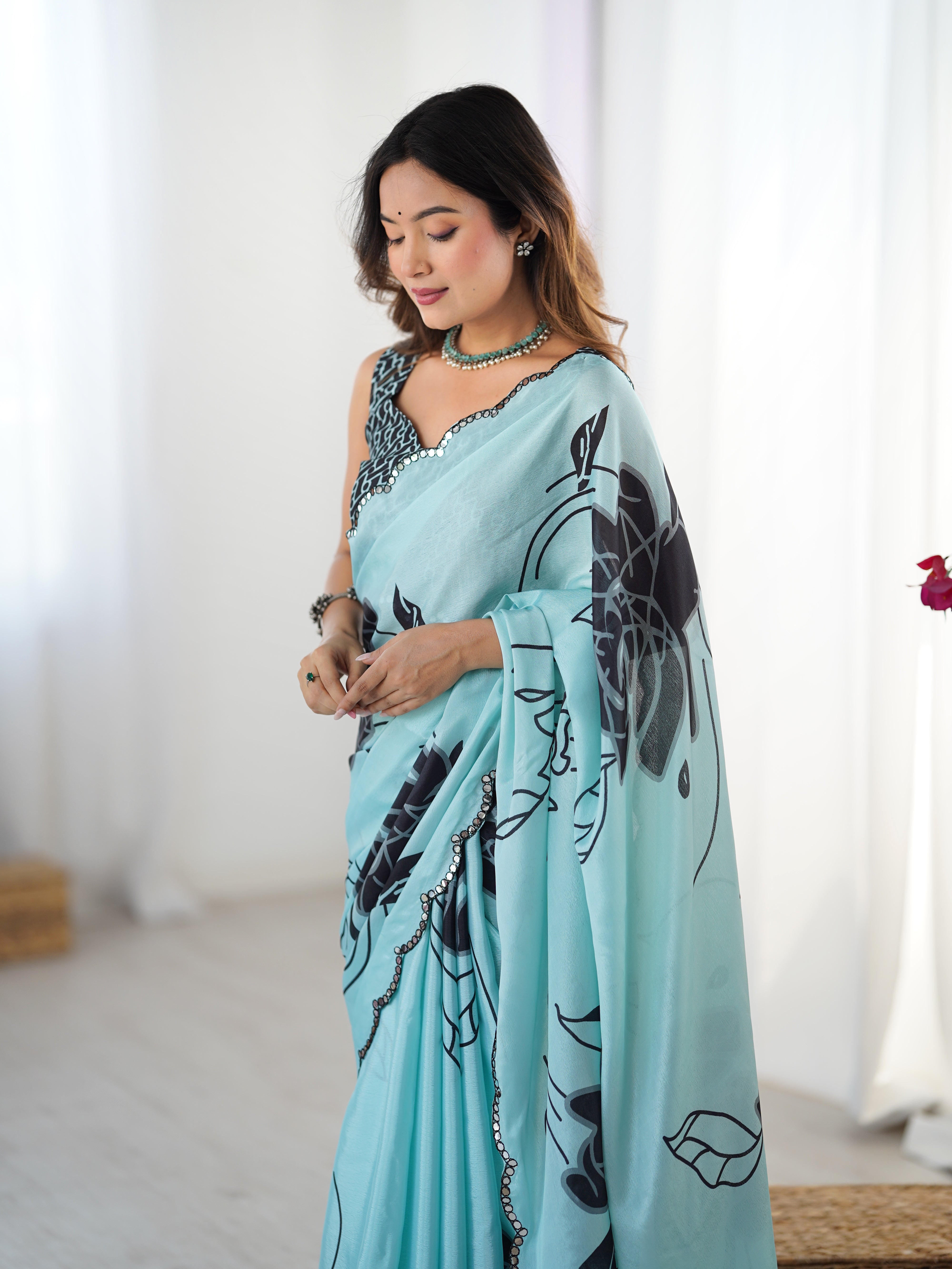 Elegant Sky Blue Heavy Chinnon Saree with floral print & Kutchi mirror lace border by TRENDBUY