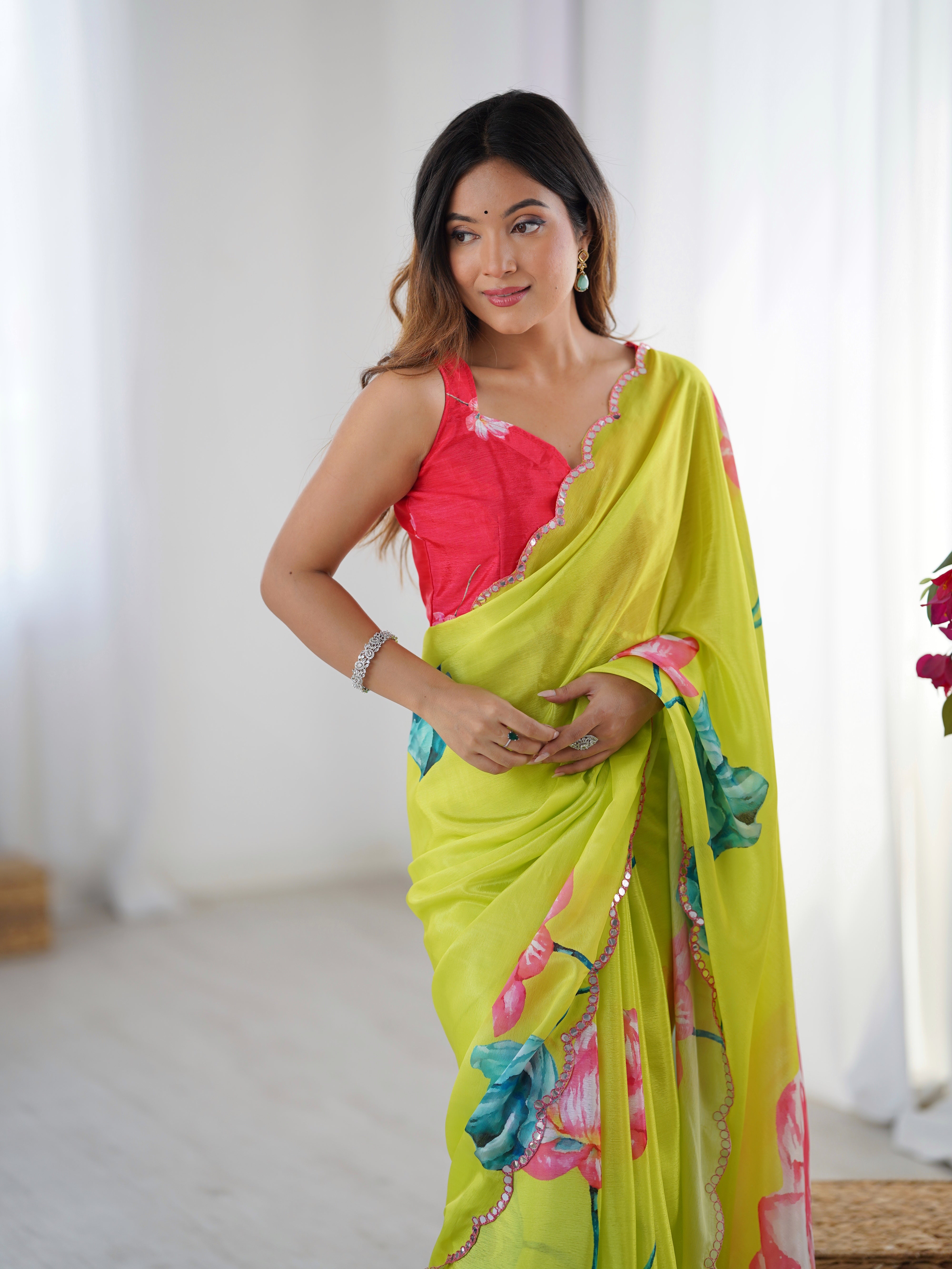 Model smiling, showcasing the overall look of the lime green floral Chinnon saree and accessories.