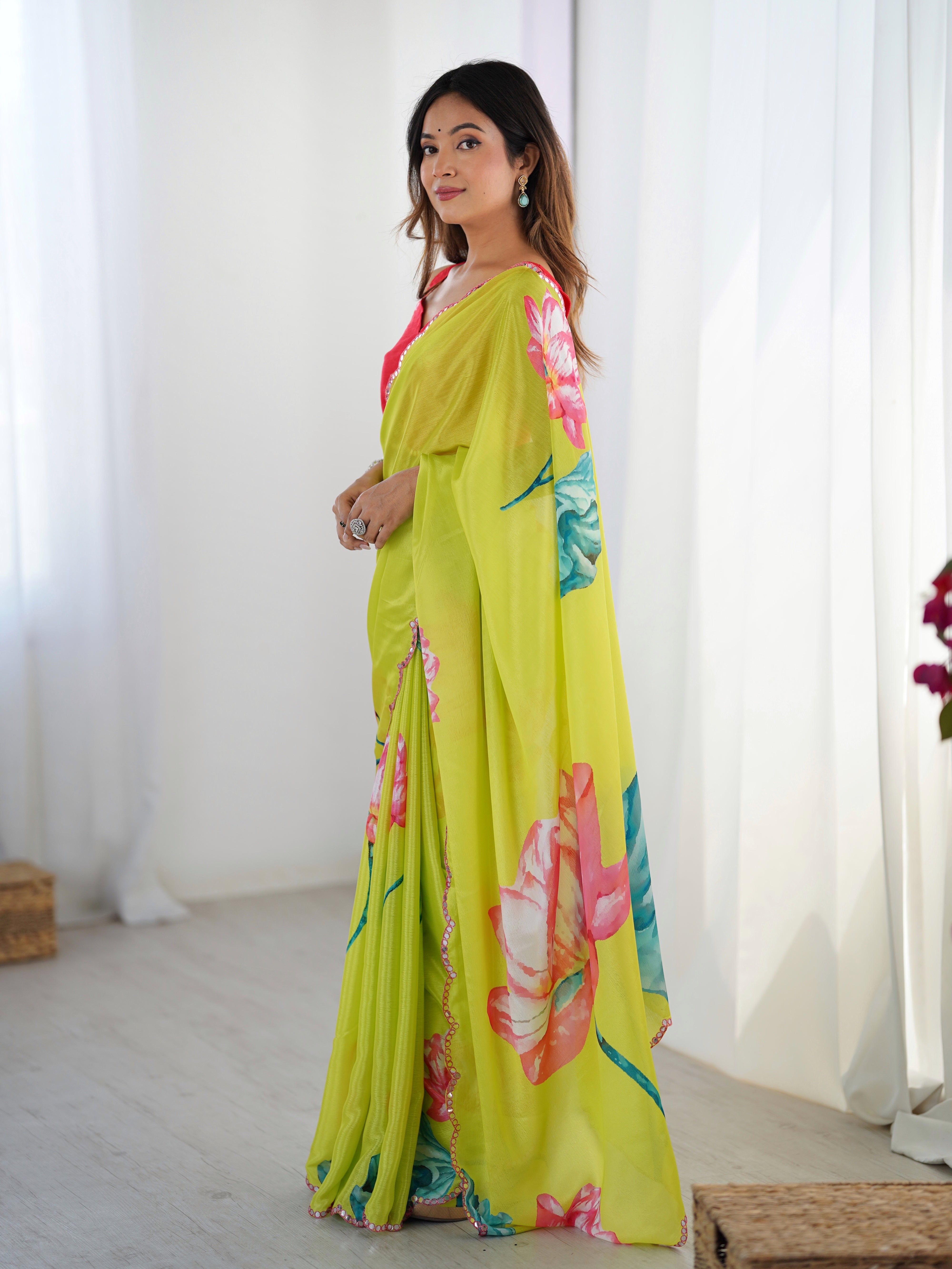 Side profile of model in traditional Indian attire, highlighting the vibrant colors and detailed saree border.