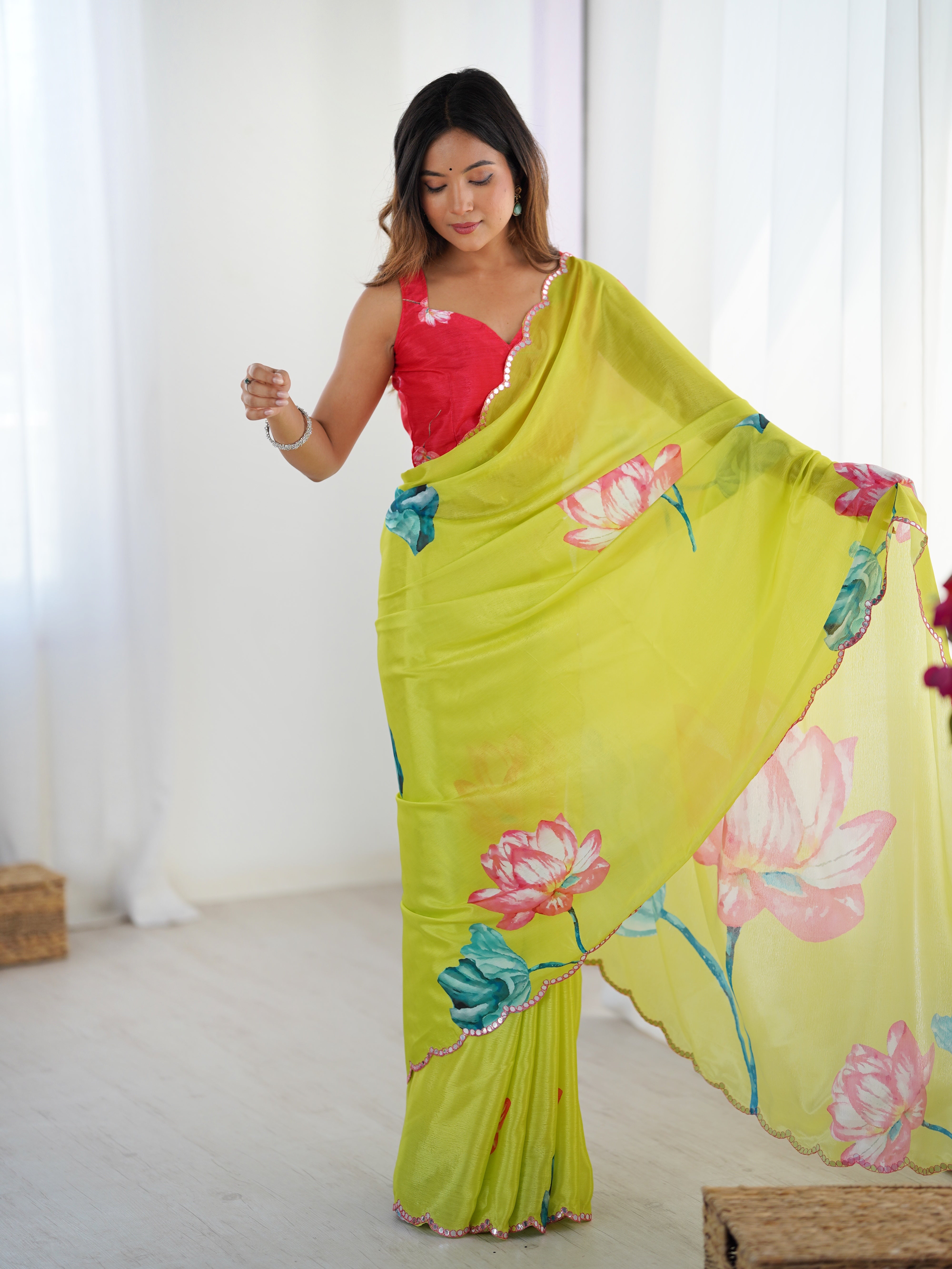 Model with saree pallu draped over shoulder, emphasizing the light fabric and floral motifs.