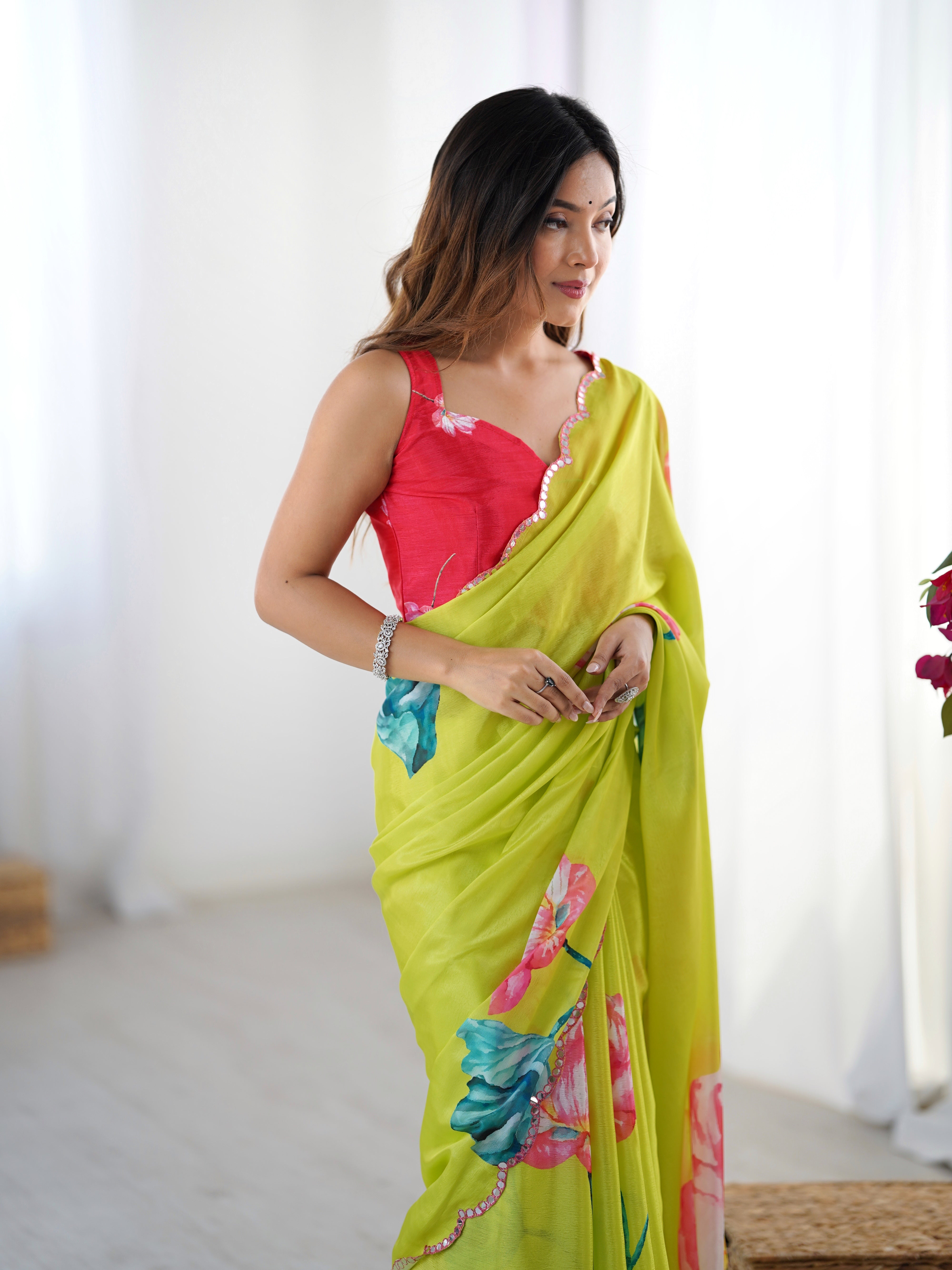 Close-up of model's mid-section, focusing on the red blouse and the detail of the saree's Kutchi mirror lace.