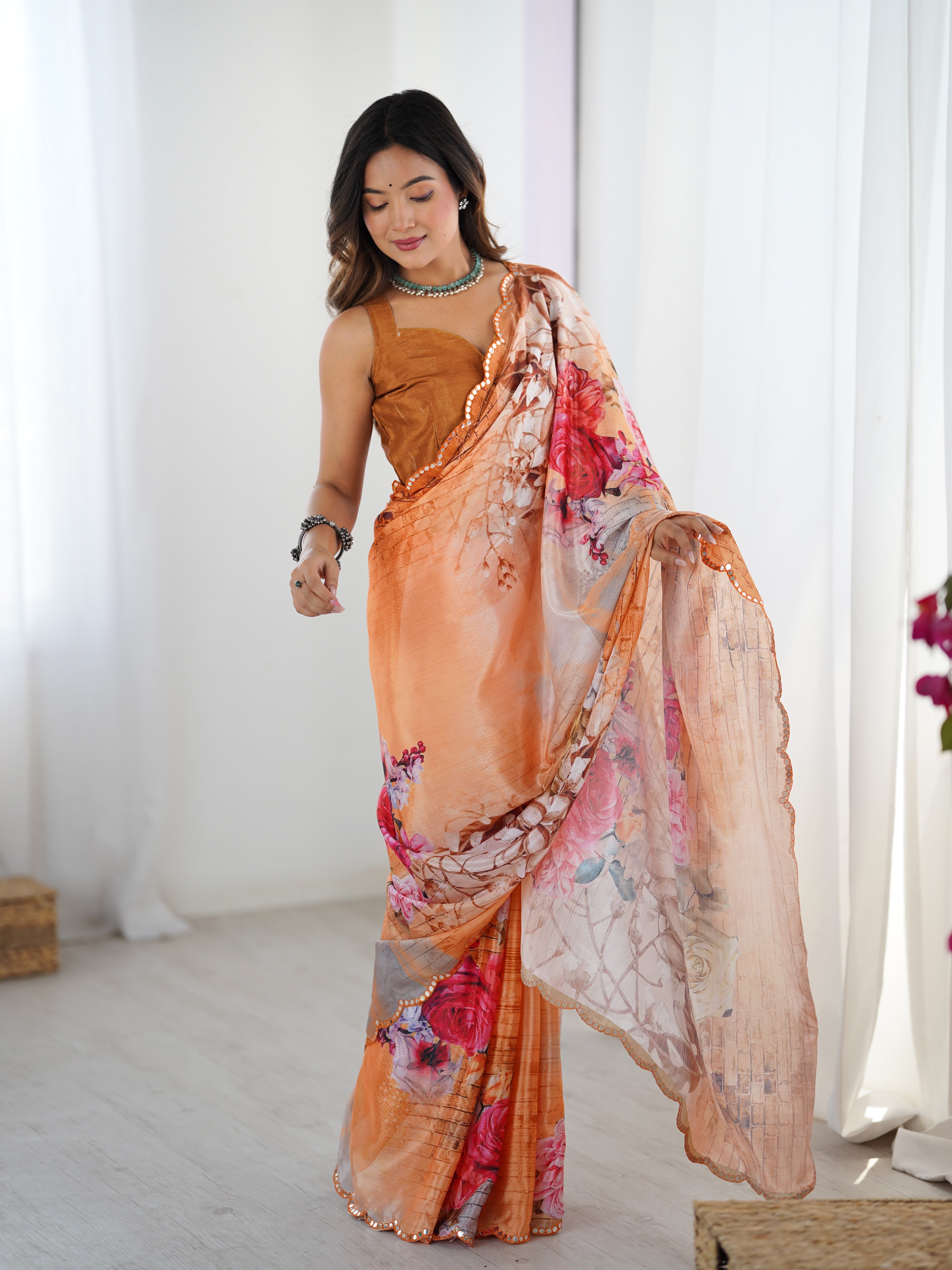 Graceful movement shot of TRENDBUY peach chinnon saree, showing its light drape and shimmering border.