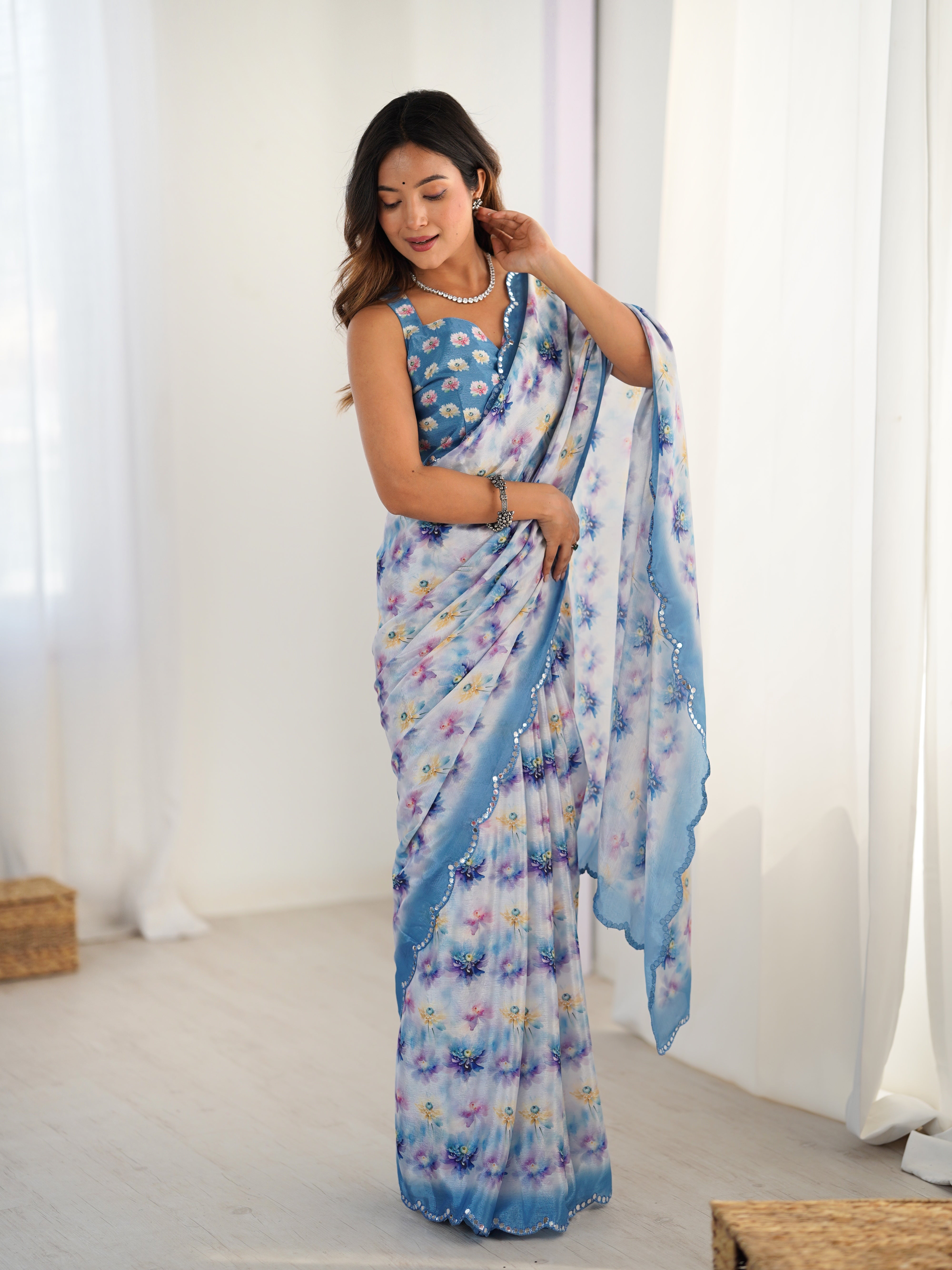 Exquisite Chinnon Saree with Kutchi mirror work lace border and floral print.