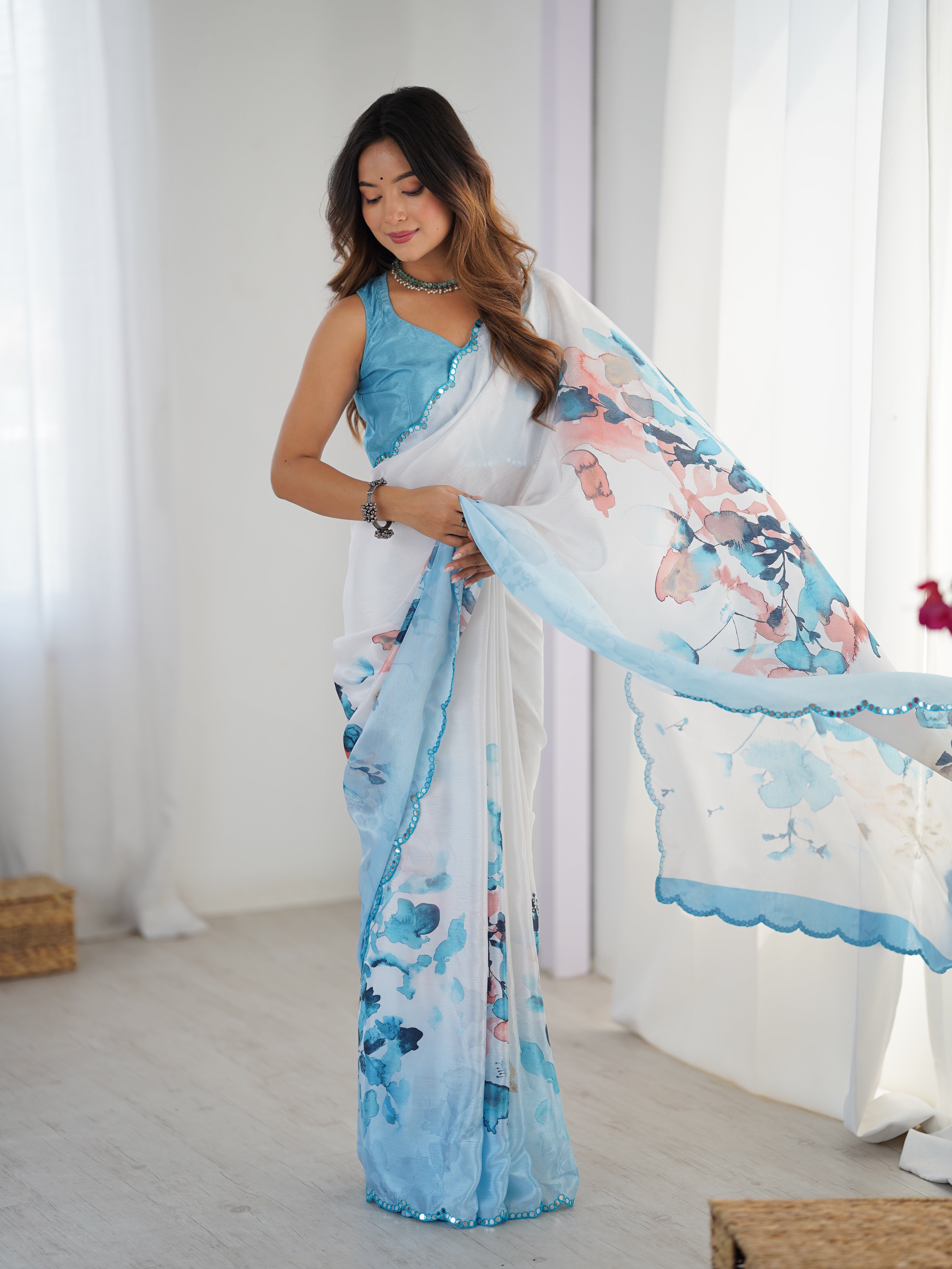 Elegant heavy Chinnon saree with Kutchi mirror lace border.