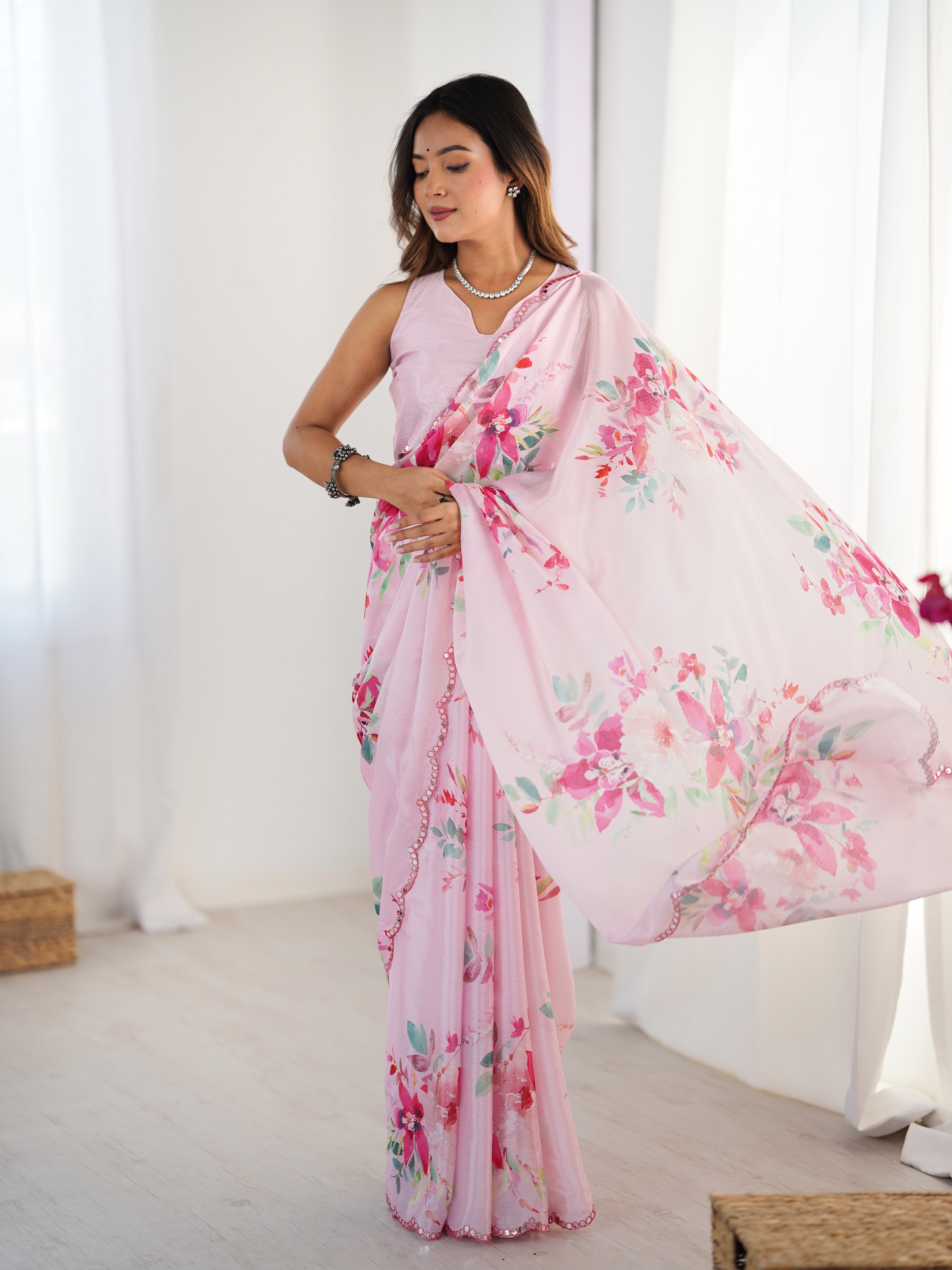 Elegant pink floral print heavy chinnon saree with Kutchi mirror lace border.