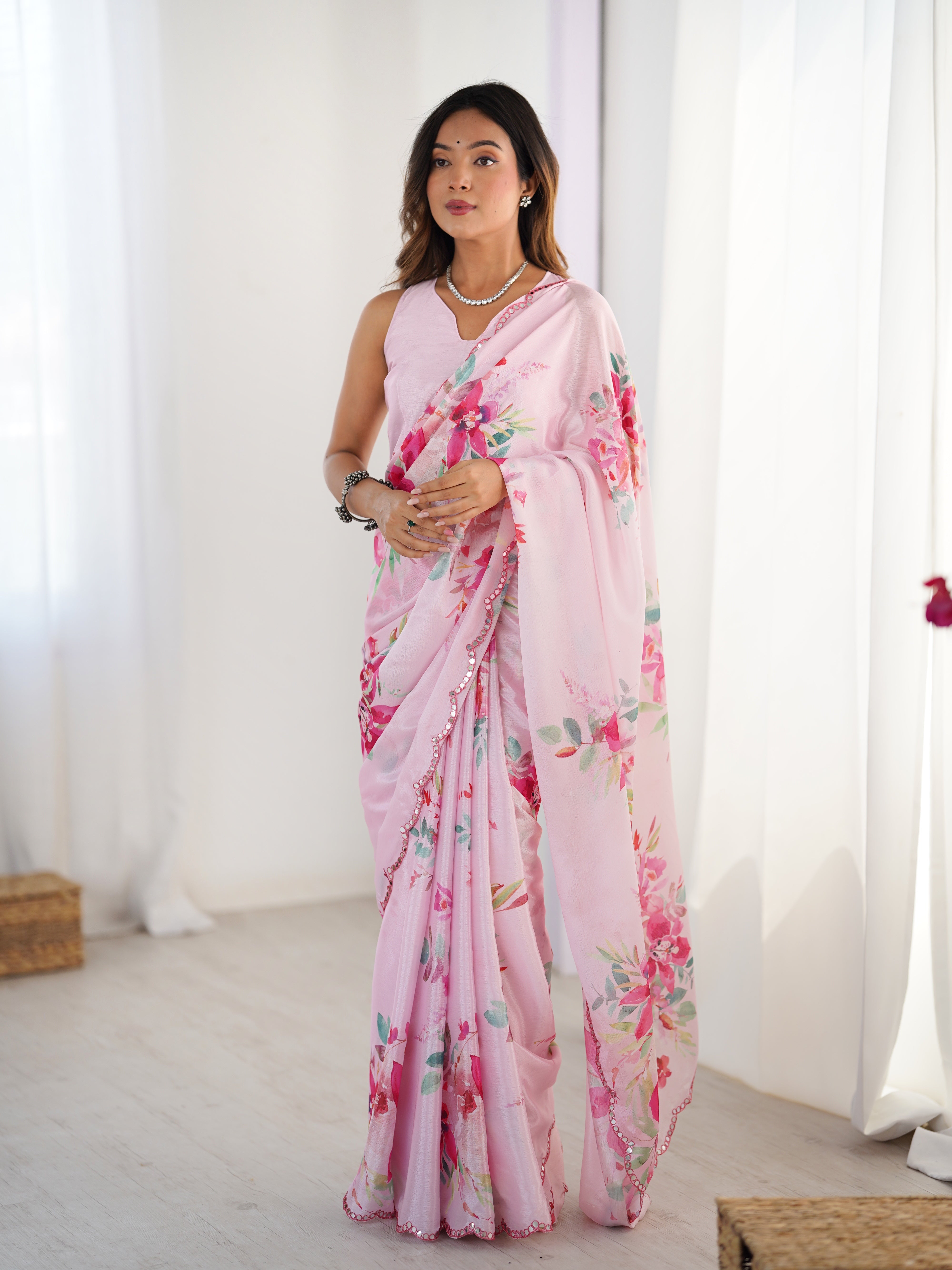 Elegant pink floral print heavy Chinnon saree with Kutchi mirror lace border.