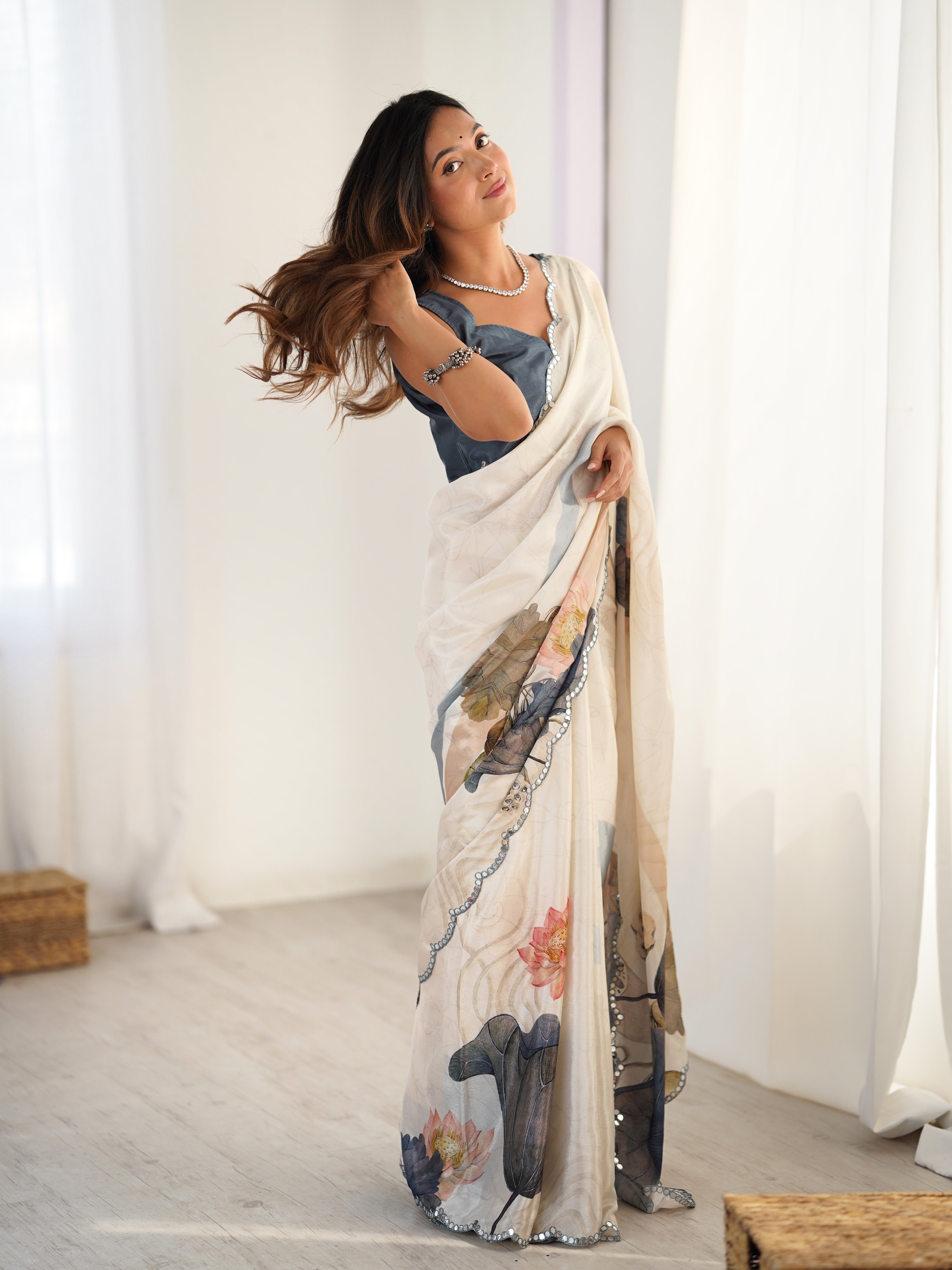 Heavy Chinnon Saree with elegant lotus print and dazzling Kutchi mirror lace border.