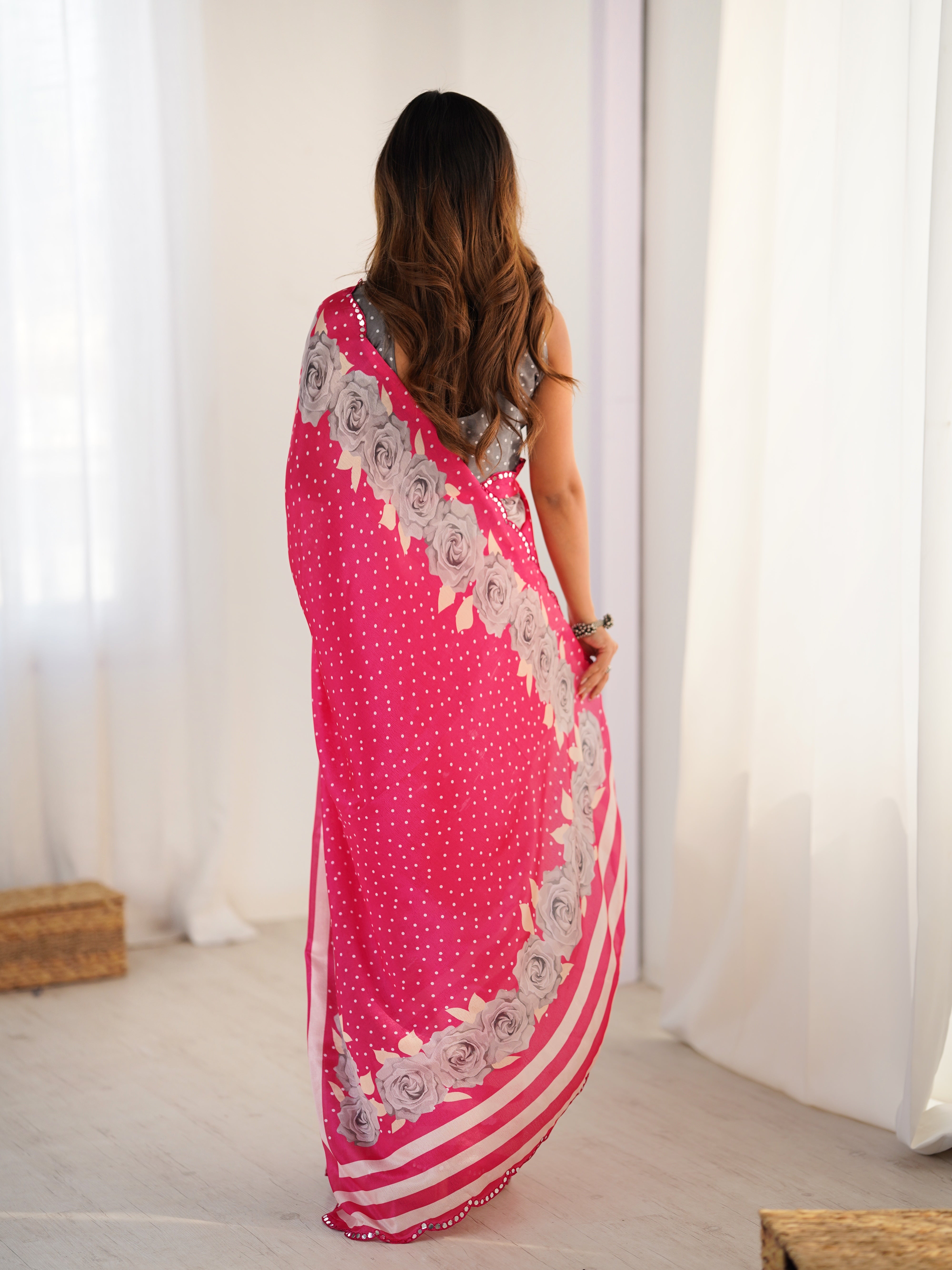 Elegant pink Chinnon saree with detailed Kutchi mirror work lace border.