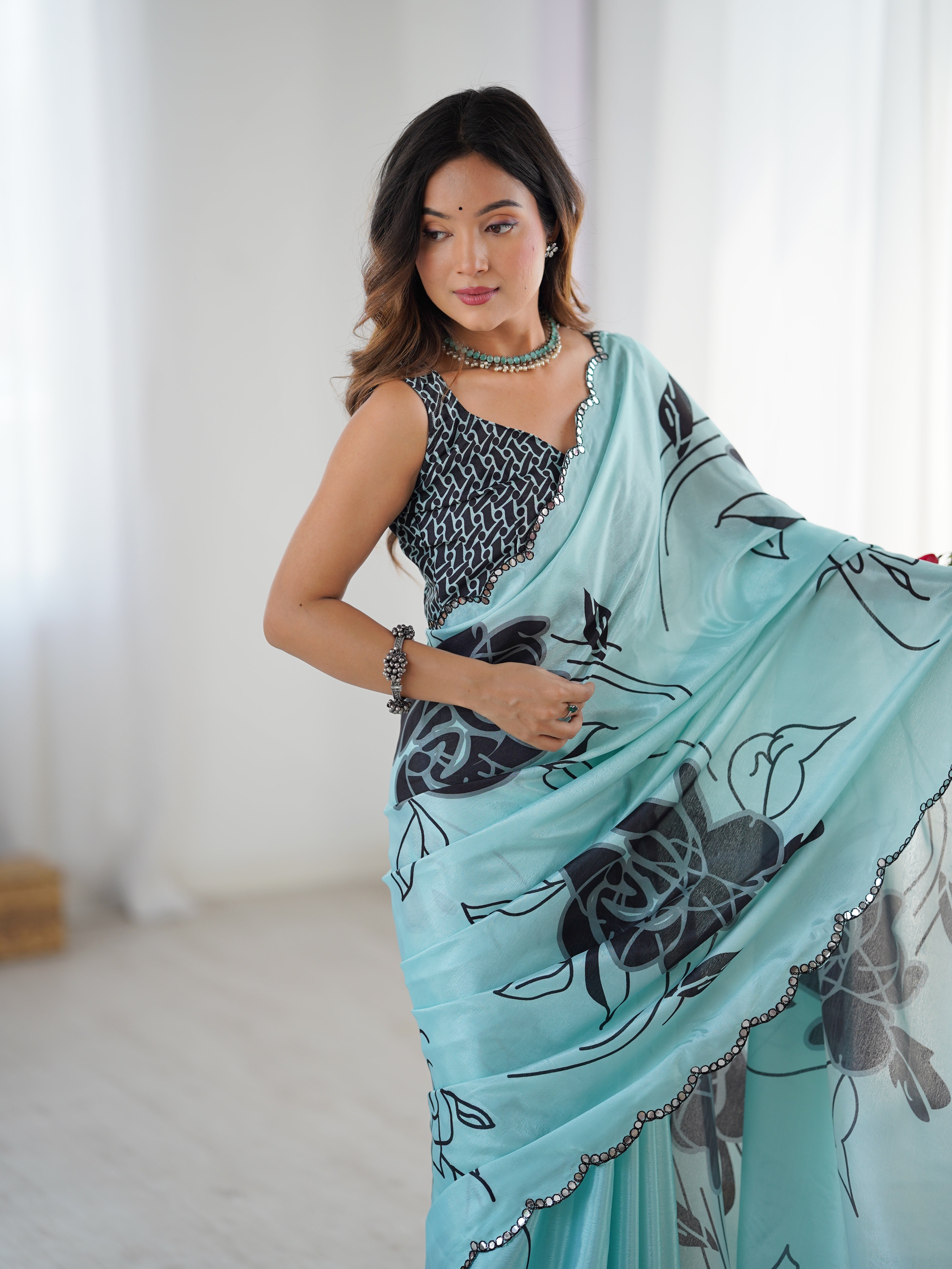 Aqua floral print Chinnon saree with dazzling Kutchi mirror border
