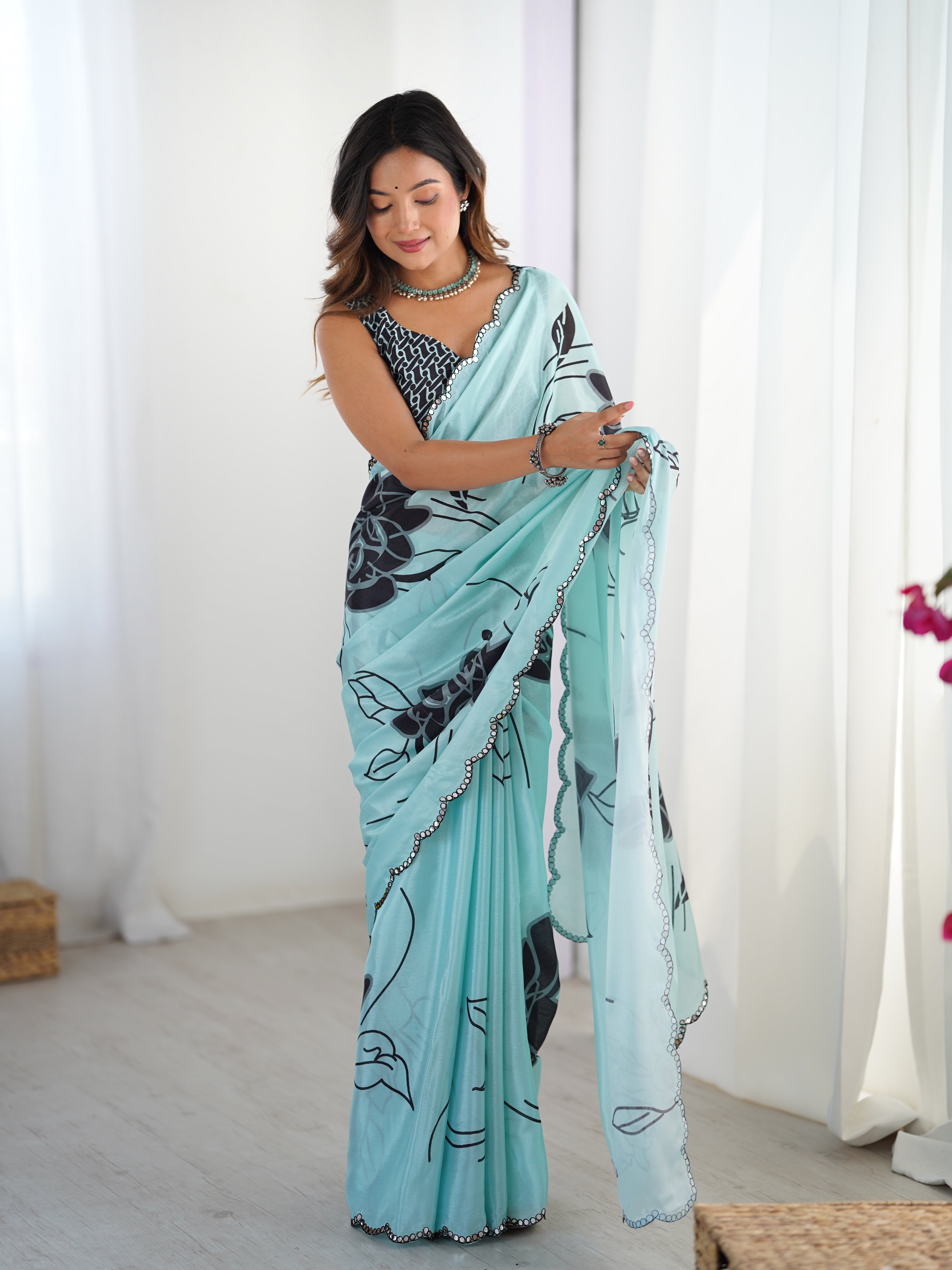 Exquisite Aqua floral Chinnon saree with dazzling Kutchi mirror border