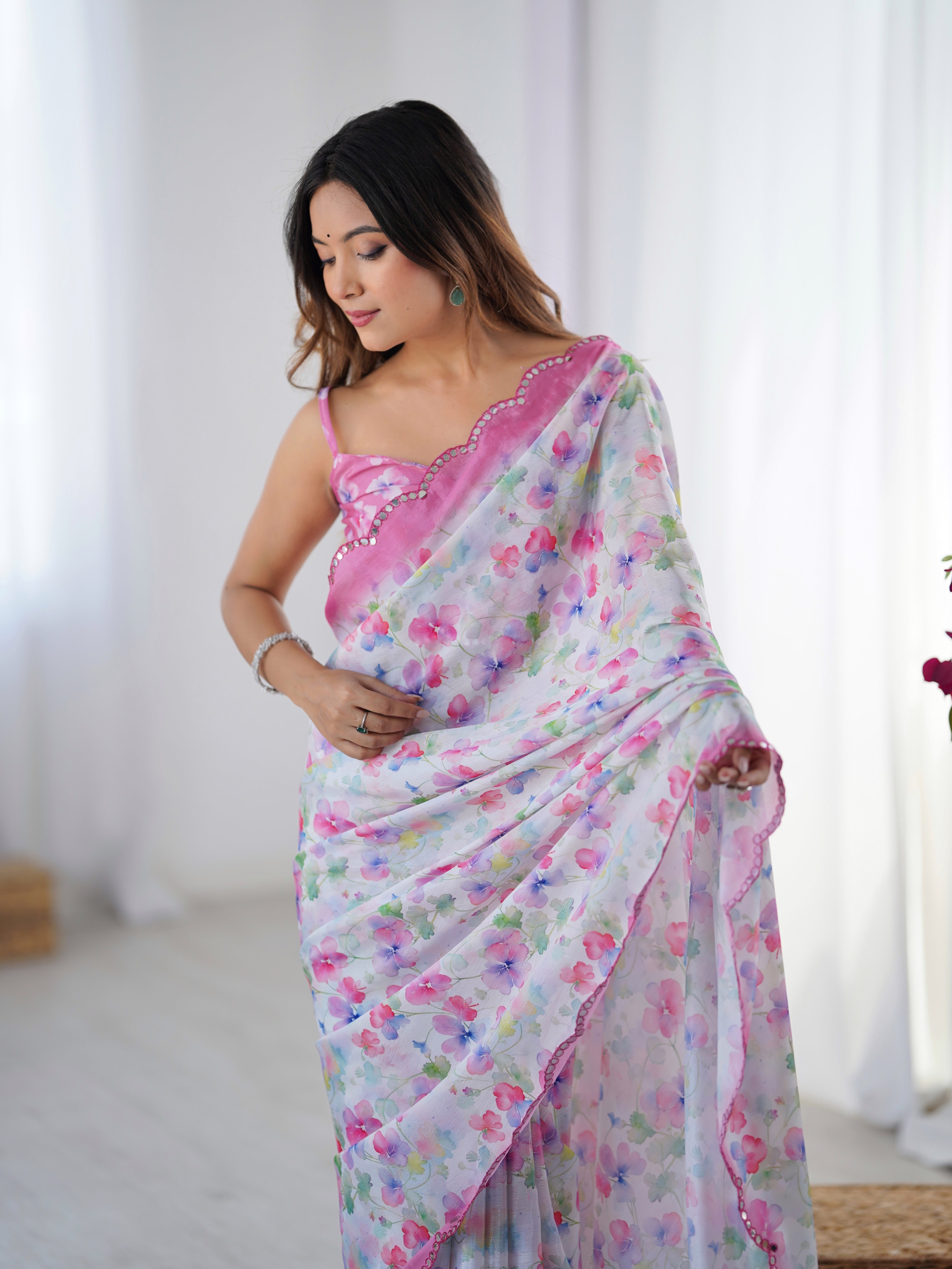 Model wearing a floral print Chinnon saree featuring a Kutchi mirror lace border & coordinating unstitched blouse.