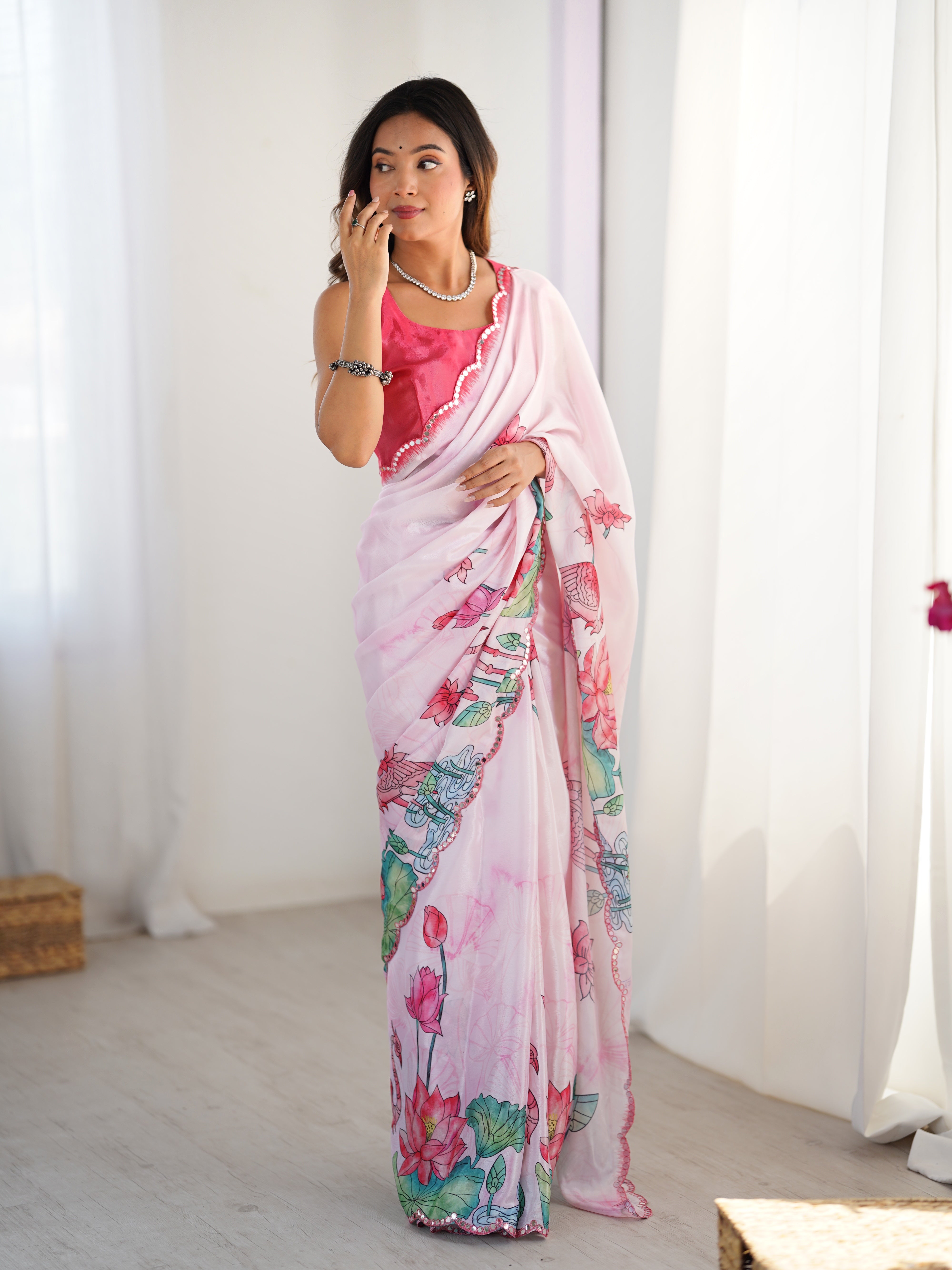 Elegant pink Chinnon saree with vibrant prints & Kutchi mirror work lace border