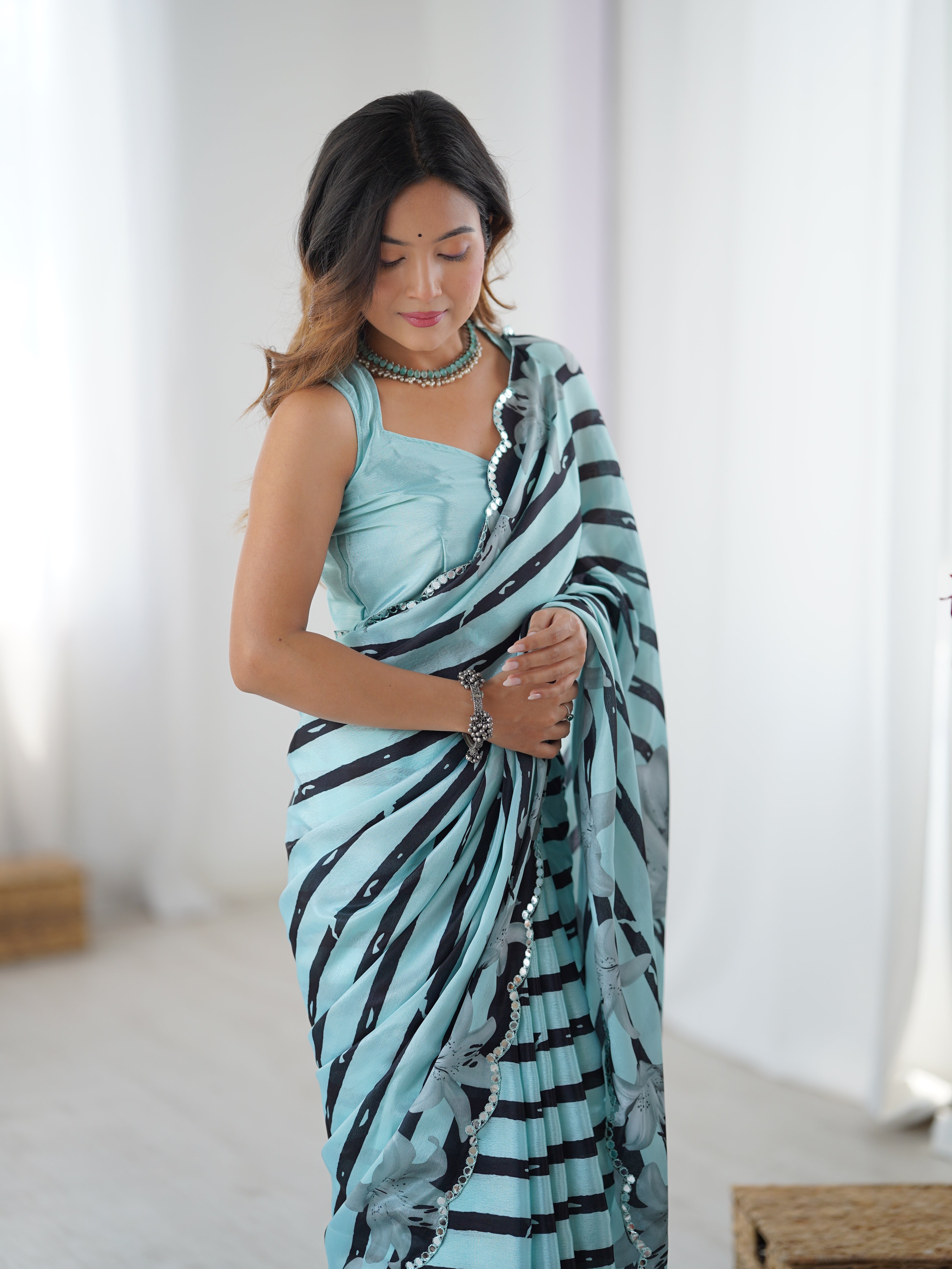 Elegant Aqua Blue Heavy Chinnon Saree with Striped Print & Kutchi Mirror Lace, shown on model.