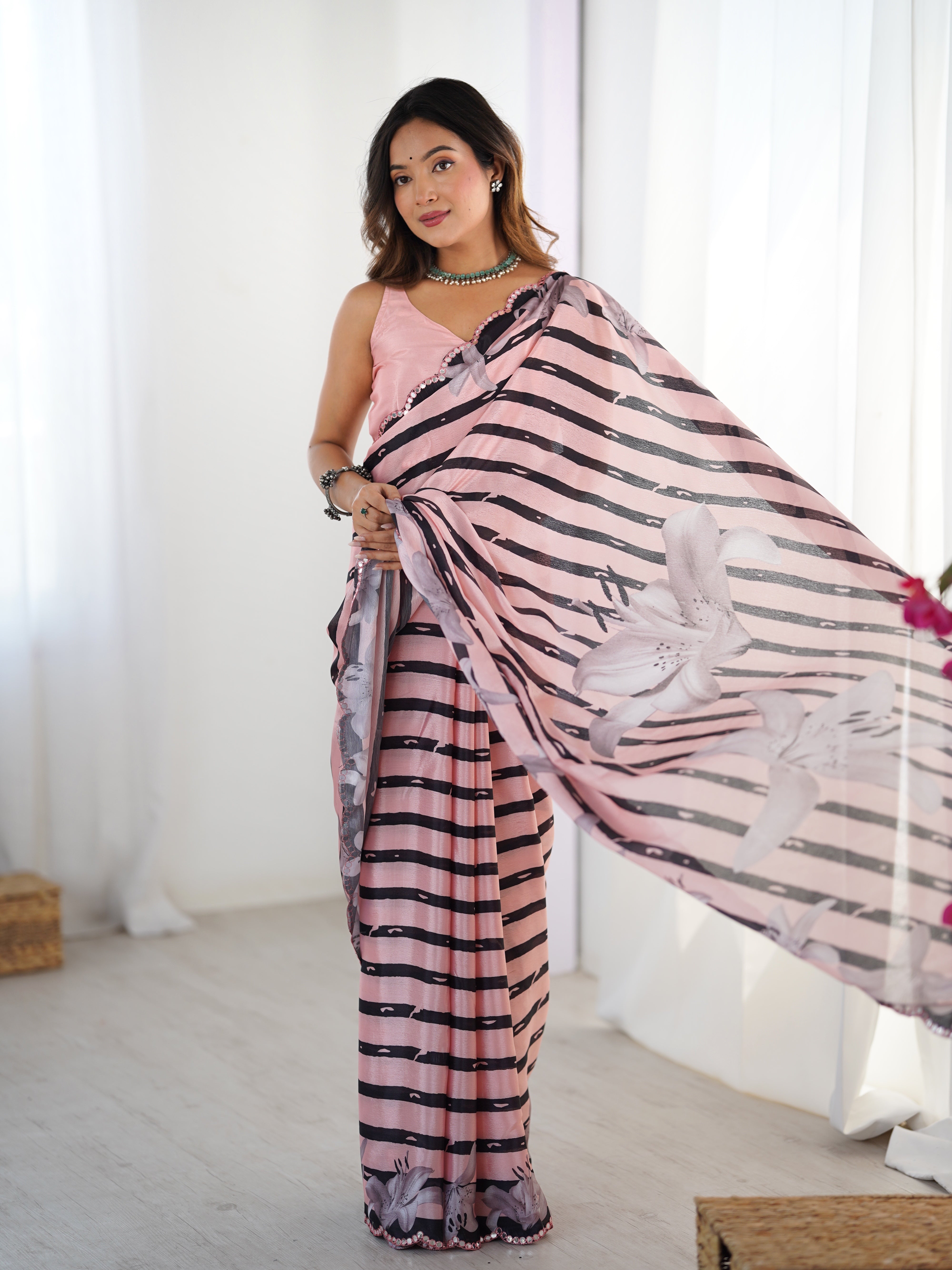 Elegant pink & black striped chinnon saree featuring Kutchi mirror lace.