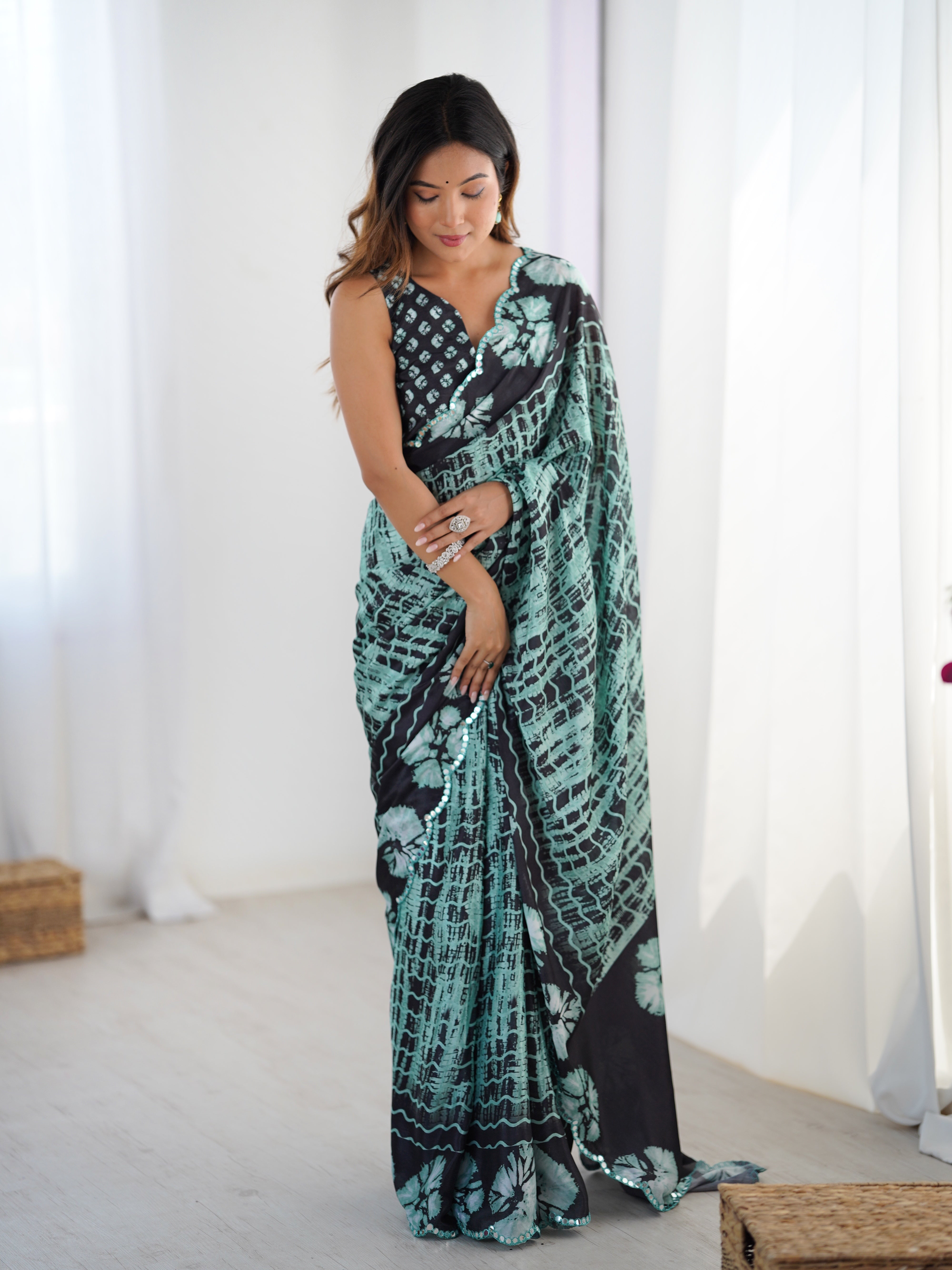 Elegant heavy chinnon saree featuring a detailed Kutchi mirror work border.