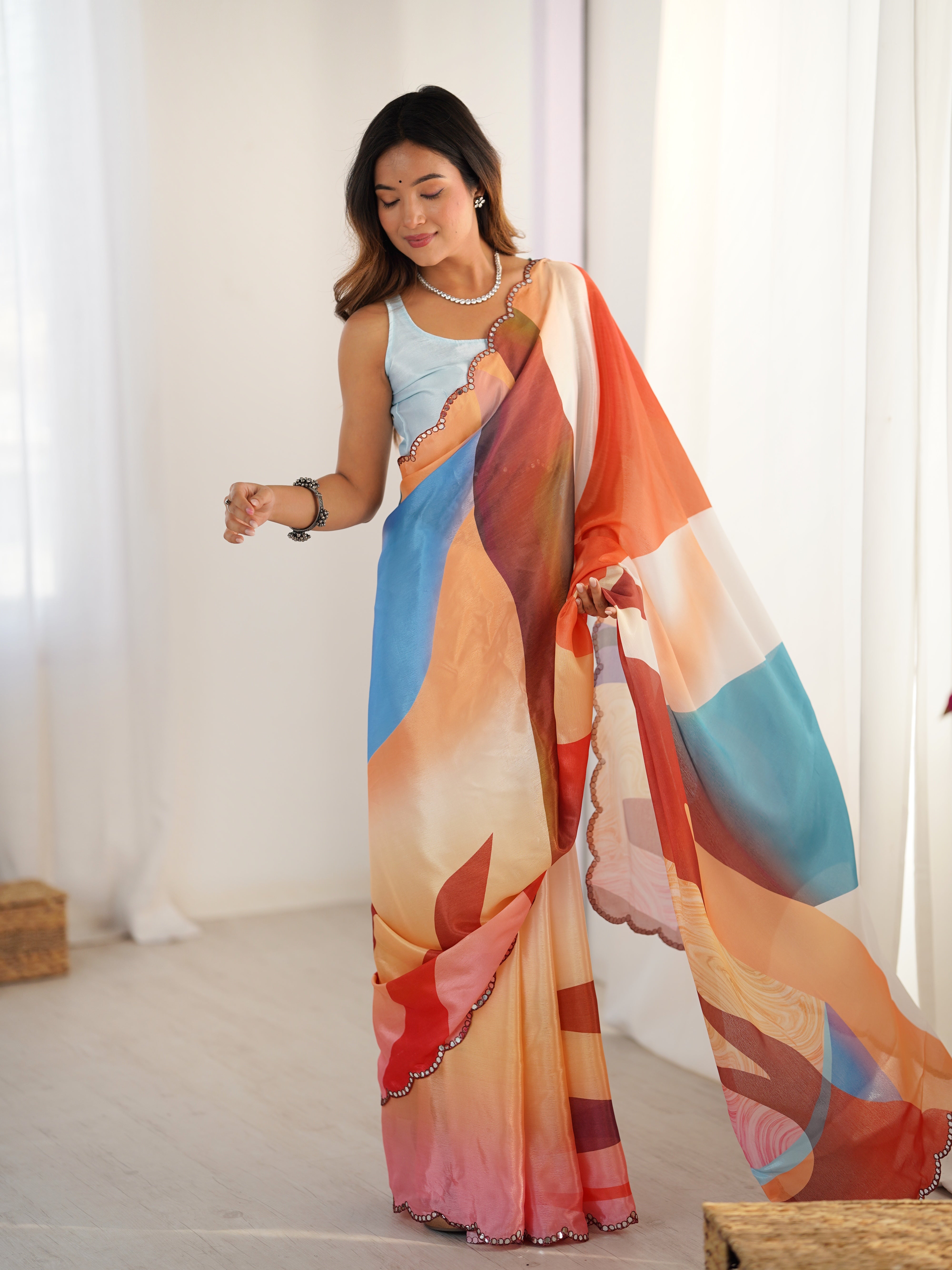 Heavy Chinnon saree with vibrant print and Kutchi mirror work border