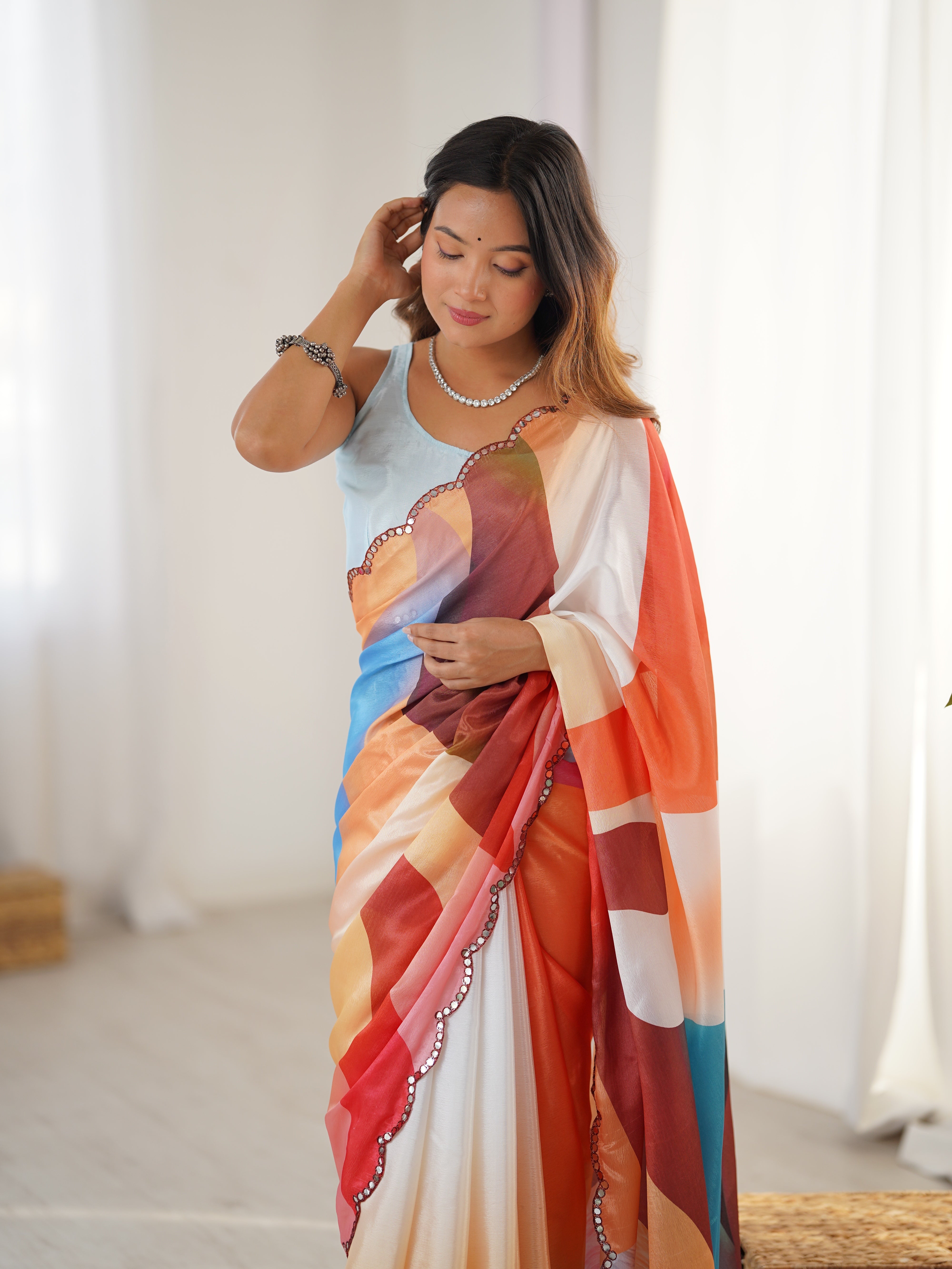 Elegant heavy Chinnon saree featuring vibrant print & intricate Kutchi mirror work border