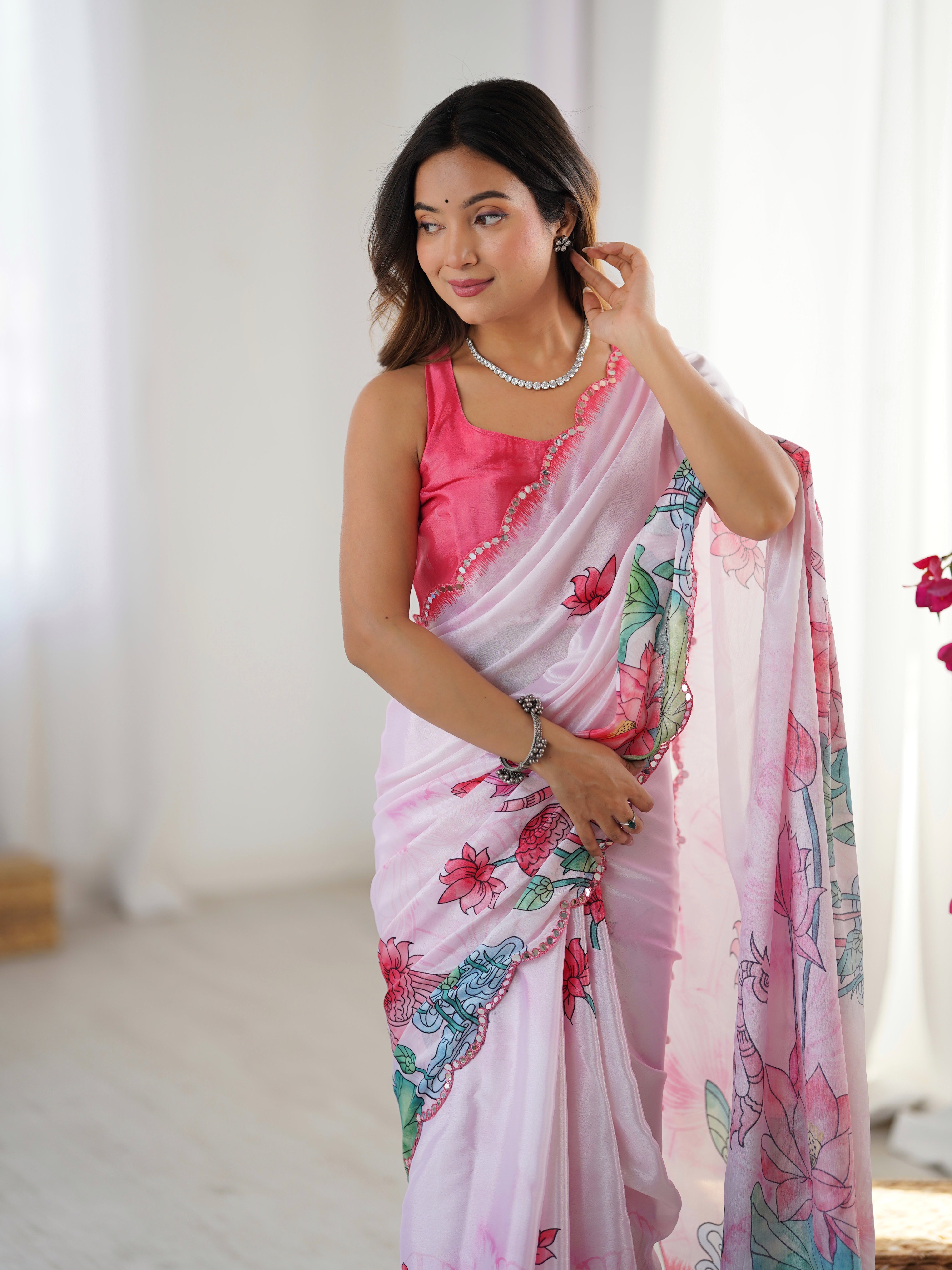 Elegant pink Chinnon saree featuring an intricate Kutchi mirror work lace border design.