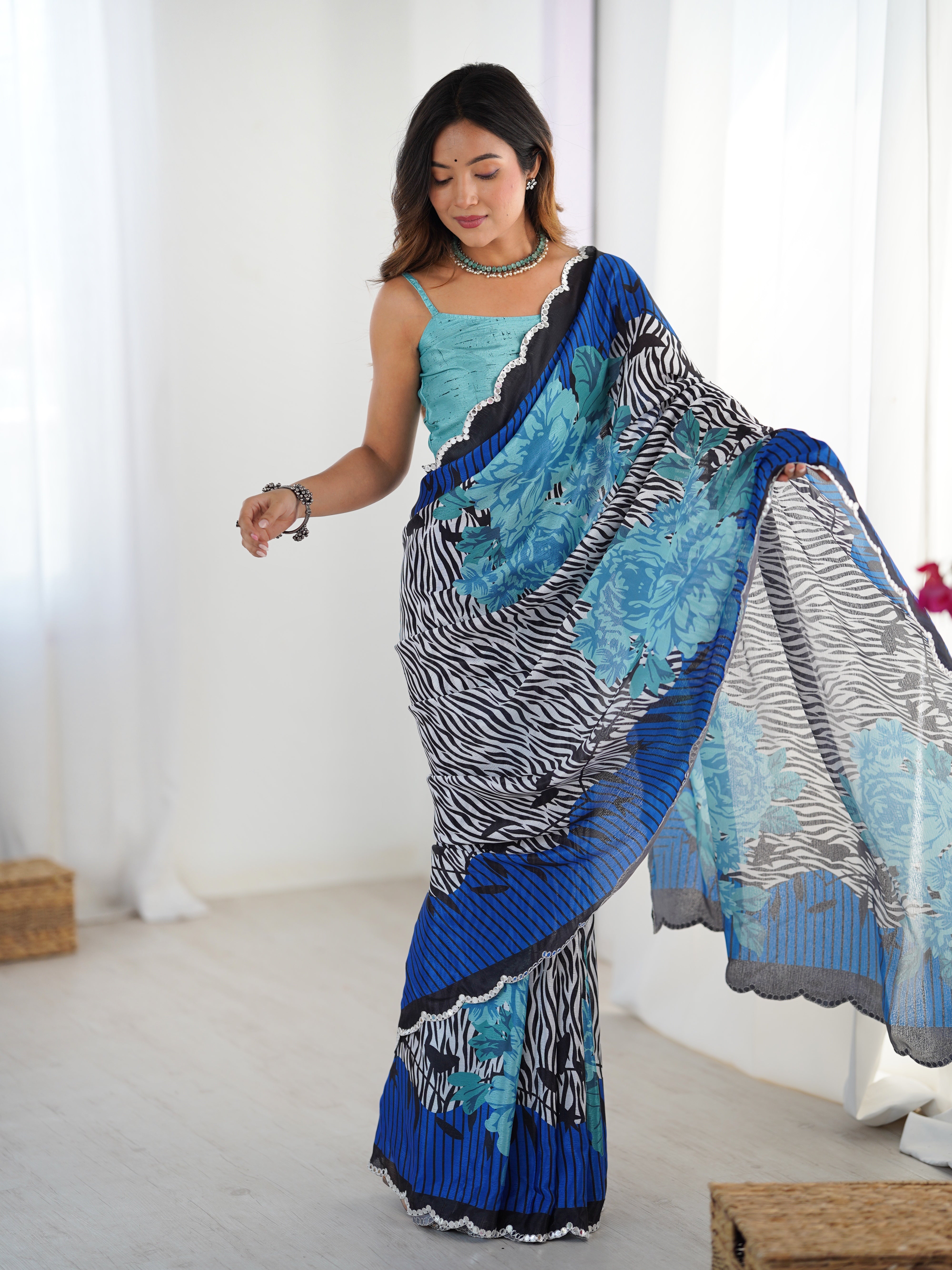 TRENDBUY Exquisite Chinnon Saree with vibrant print and Kutchi mirror lace border, worn by model.