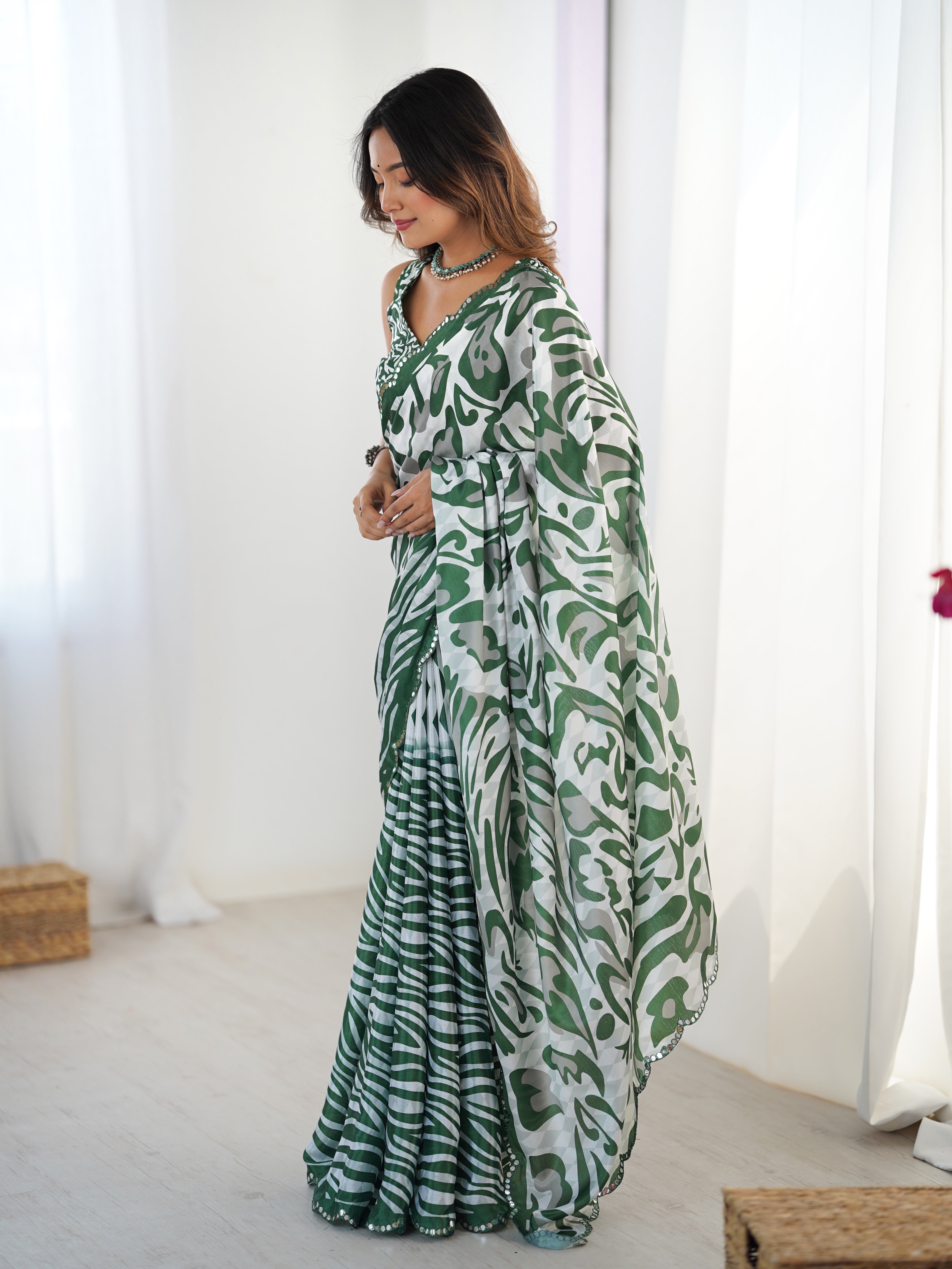 Heavy chinnon saree with Kutchi mirror lace border & intricate print.