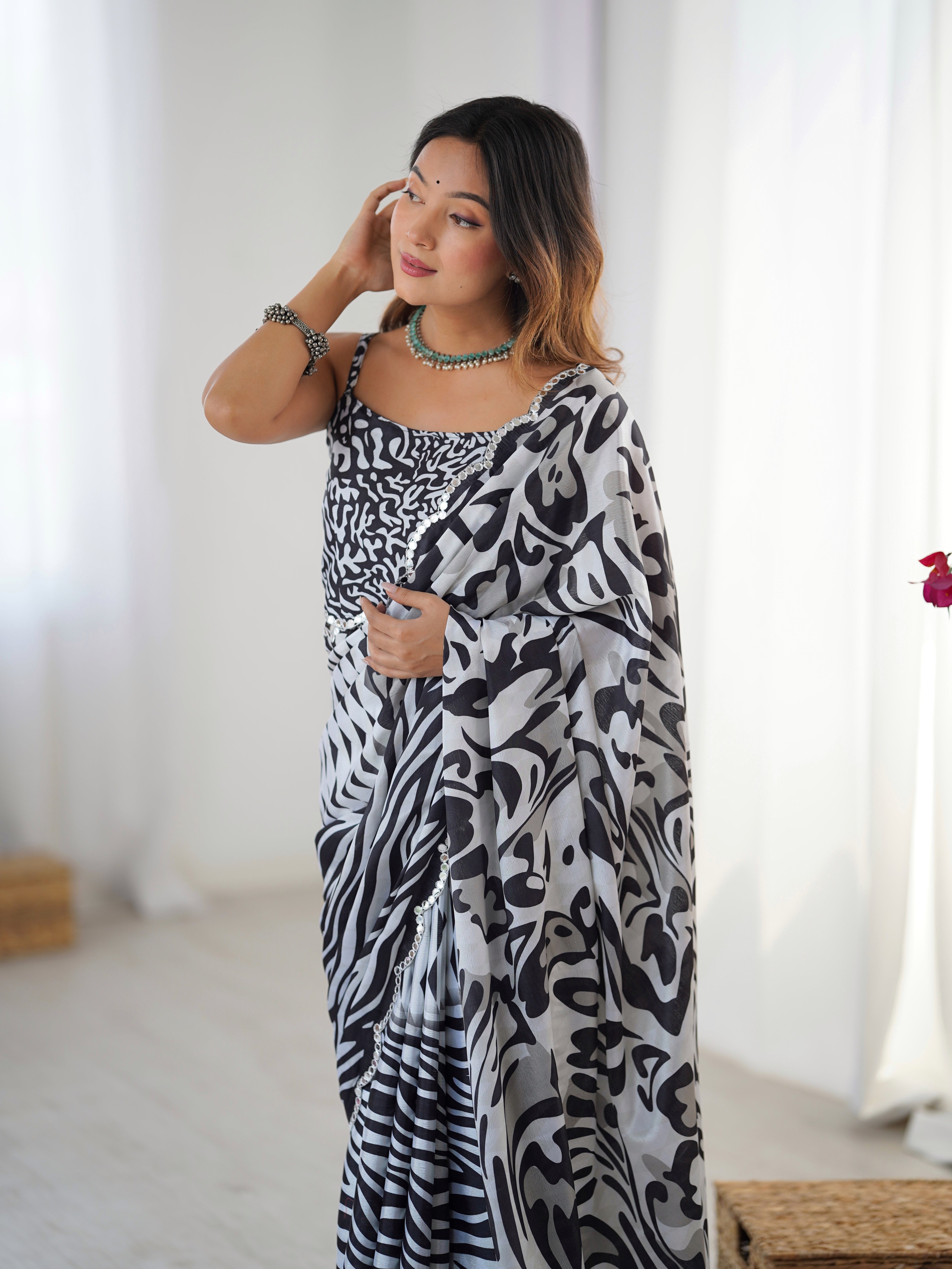 Heavy Chinnon Saree with abstract print and elaborate Kutchi mirror work lace border