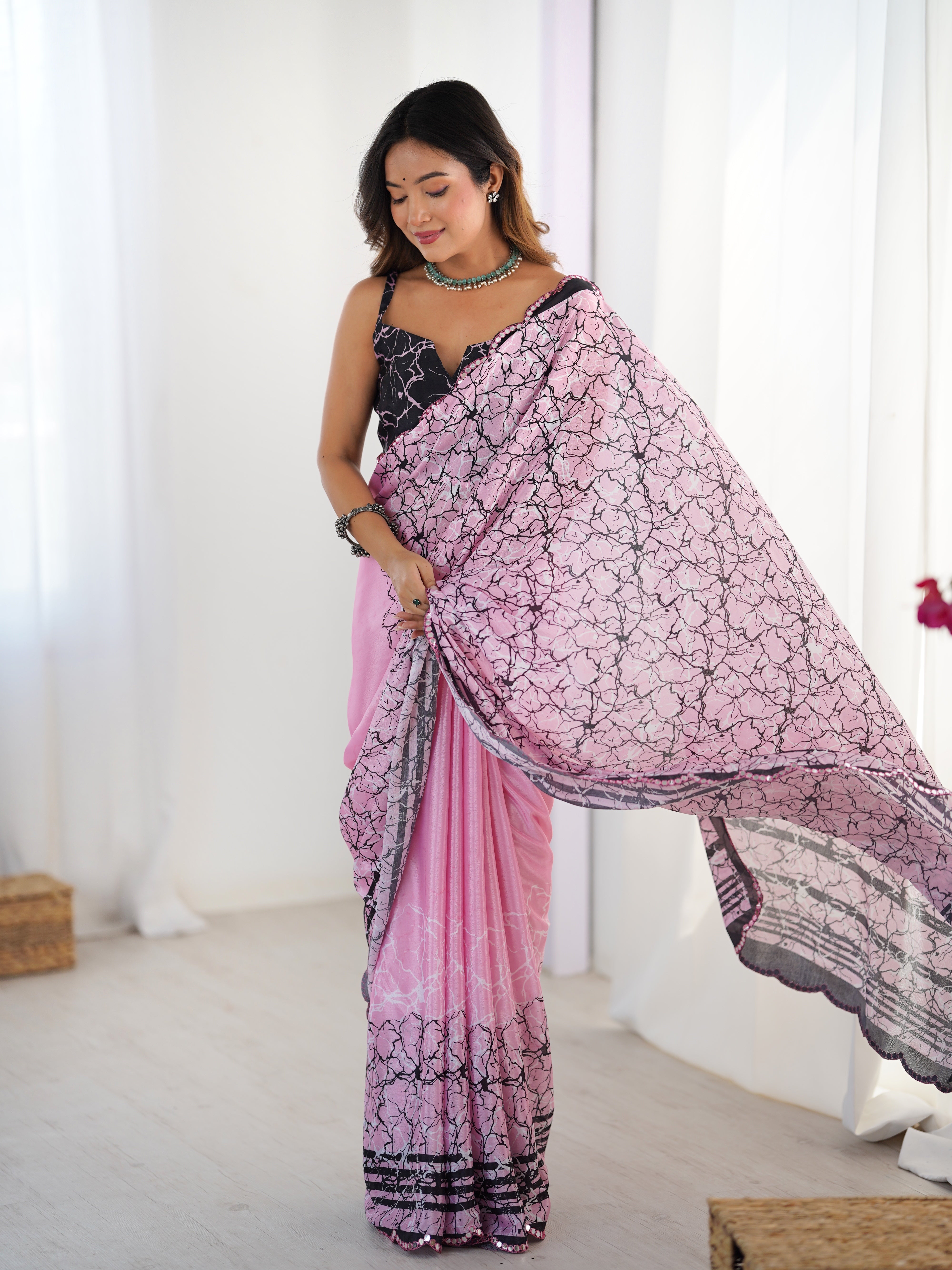Draped heavy Chinnon saree featuring elegant print and Kutchi mirror lace border.