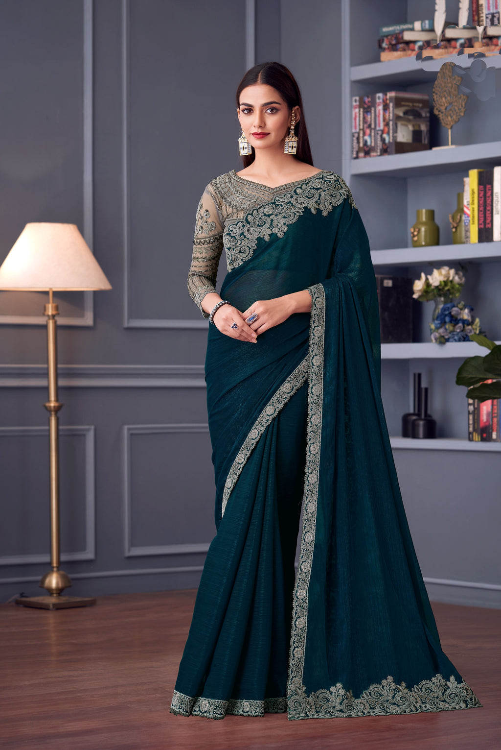 Full view of dark teal embroidered georgette saree set with ornate embellishments.