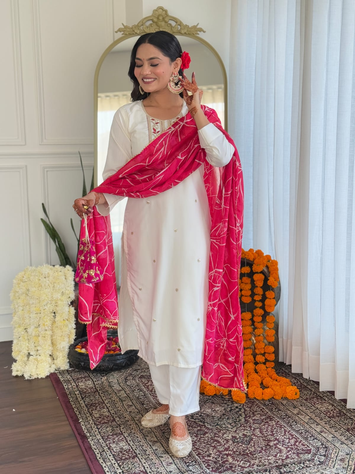 Smiling TRENDBUY model gracefully presenting the white embroidered kurti set with pink dupatta, highlighting its festive appeal and comfort.