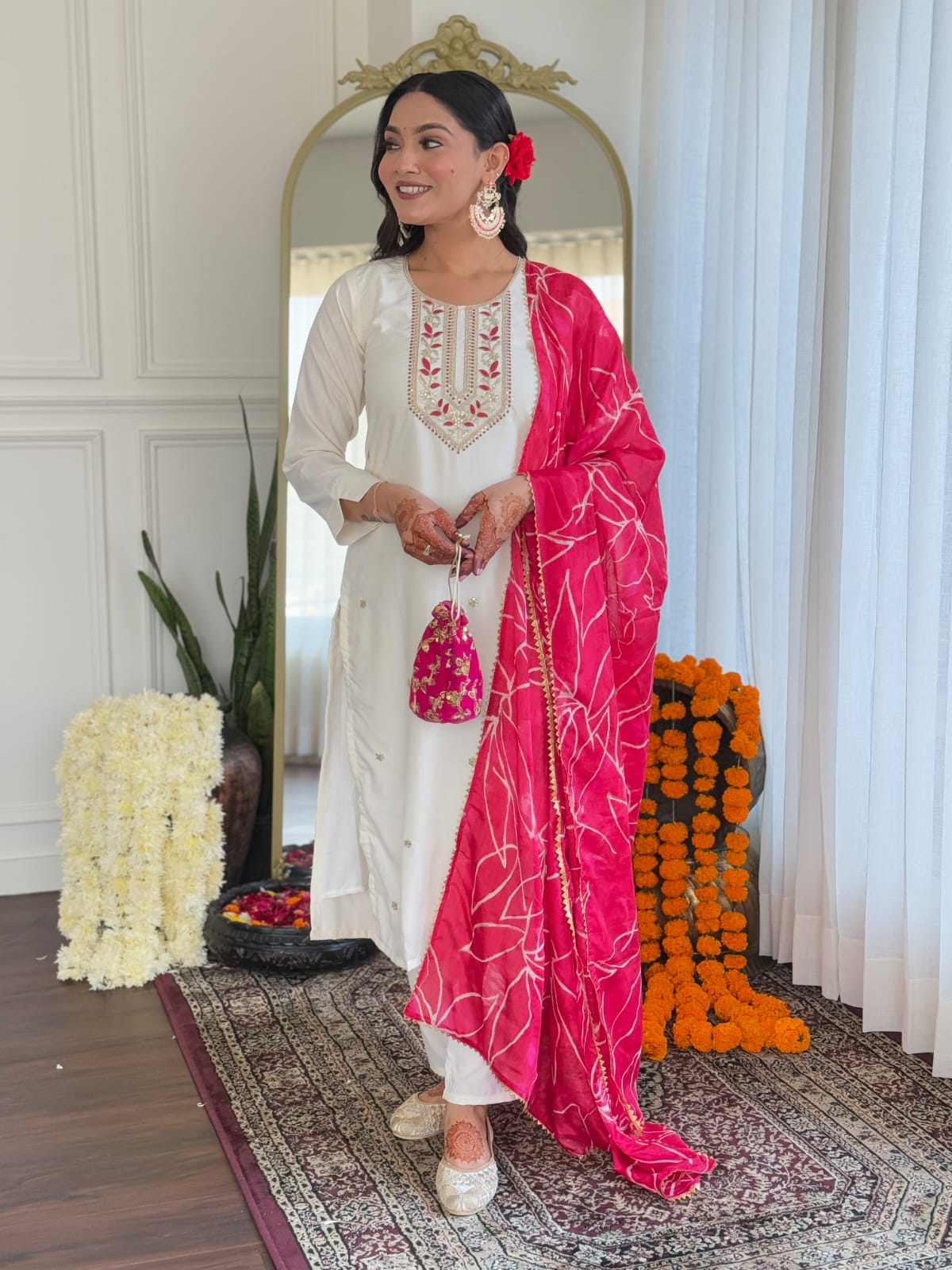 TRENDBUY model showing off the elegant drape of the white kurti set and pink dupatta, holding a matching small bag.