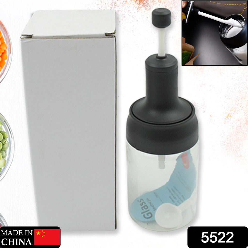 Single transparent glass spice jar with serving spoon & airtight cap for seasoning.