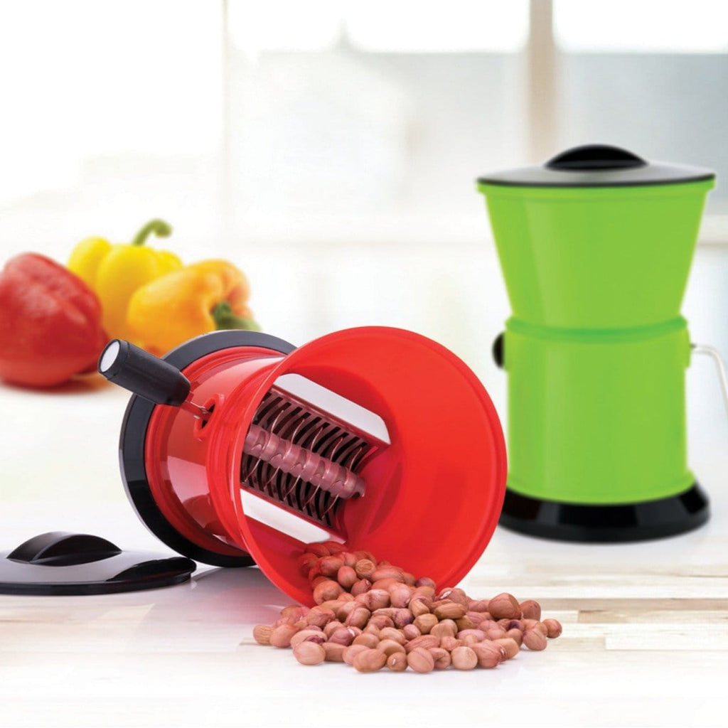 Close-up of the sharp stainless steel rotary blades inside the green plastic container.