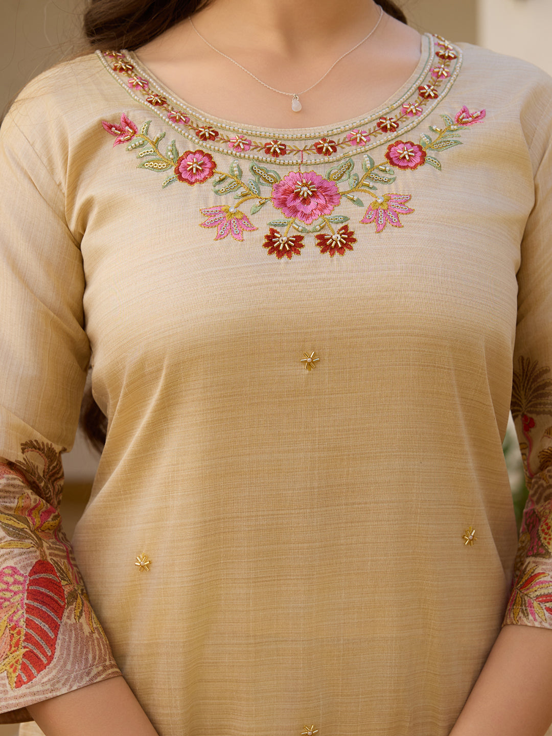 Detailed close-up of the vibrant floral embroidery and bead embellishments on the neckline of the HR-22 cream Kurta.