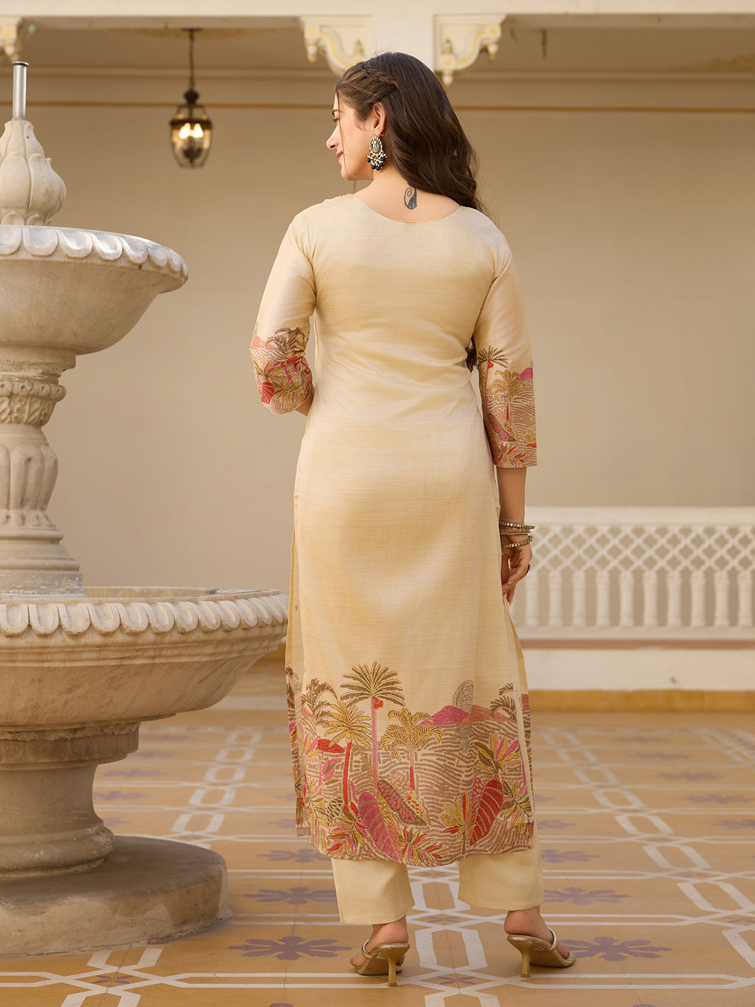 Rear view of the woman in the HR-22 TRENDBUY Kurta Set, showing the simple elegance of the back of the kurta and matching plain cream pants.